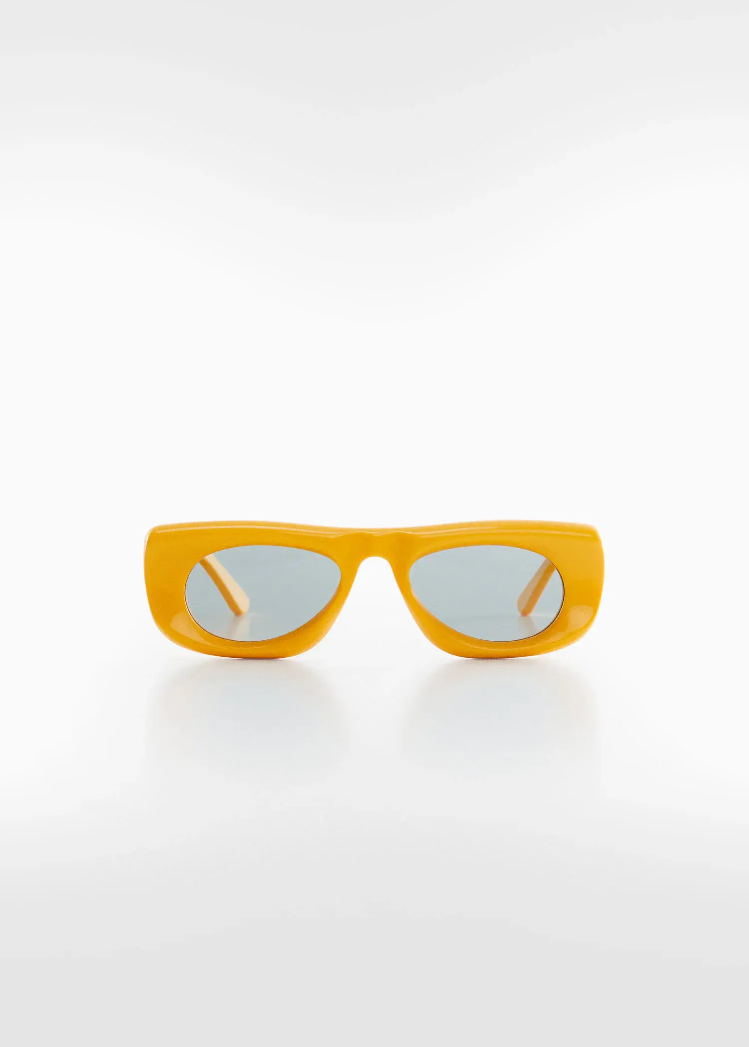 Mango Volume frame sunglasses. a pair of yellow sunglasses sitting on top of a table. 