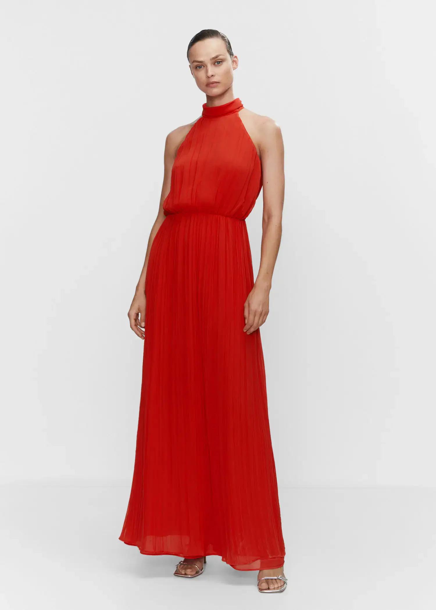 Mango Pleated halter neck dress. a woman in a red dress standing in front of a white wall. 
