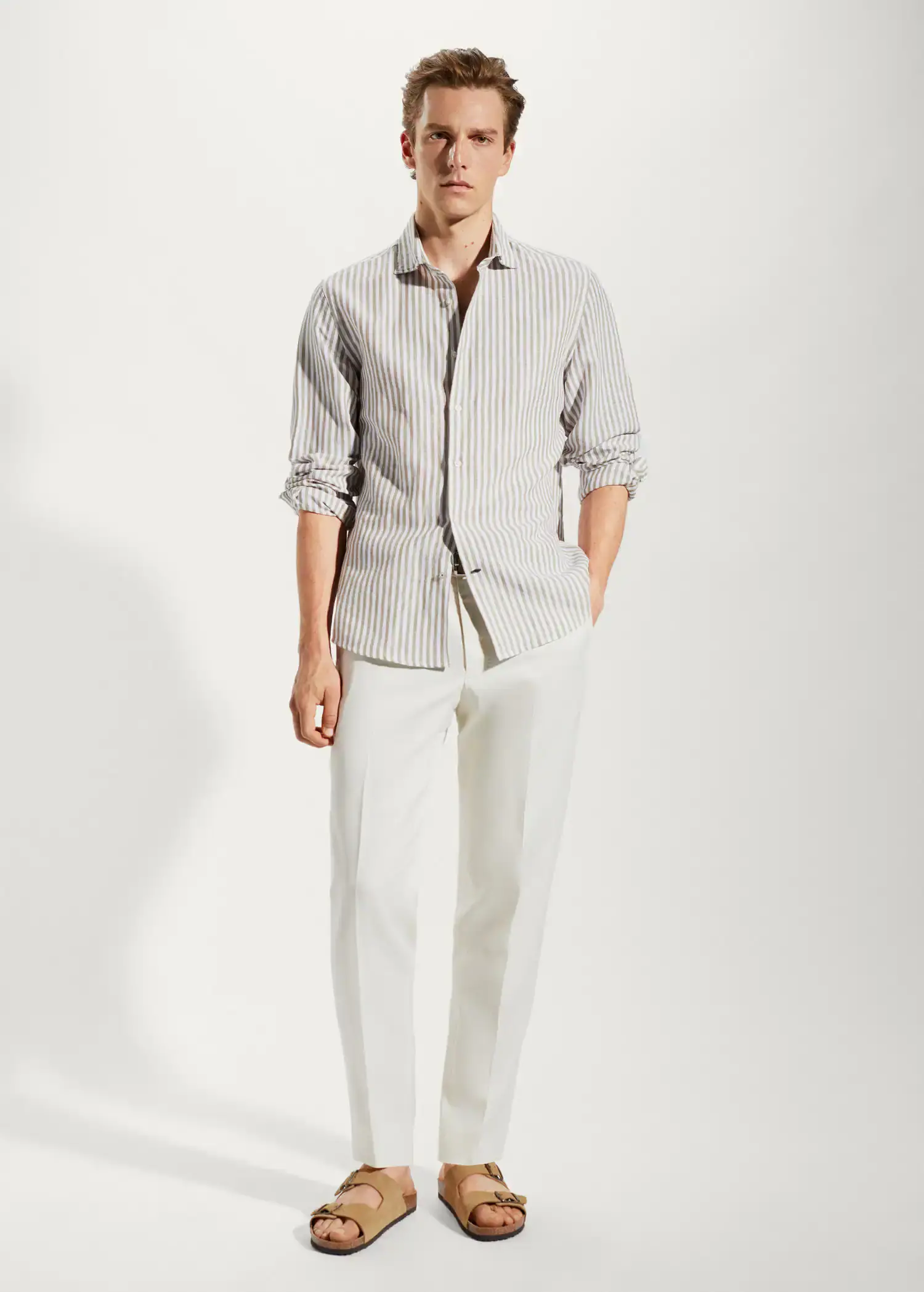 Mango Slim fit striped linen shirt. a man wearing a striped shirt and white pants. 