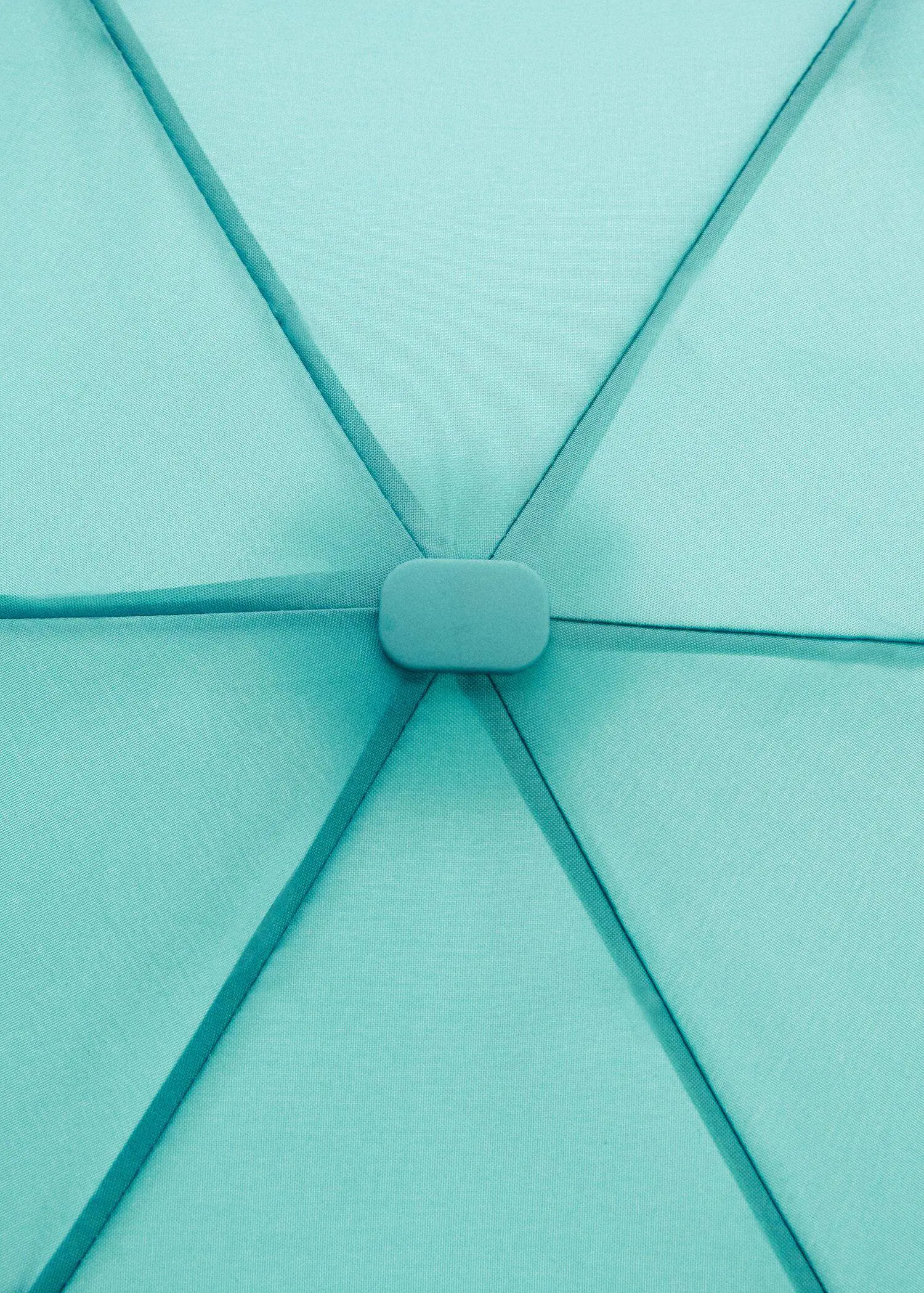 Mango Plain folding umbrella. a close-up view of the inside of a blue umbrella. 