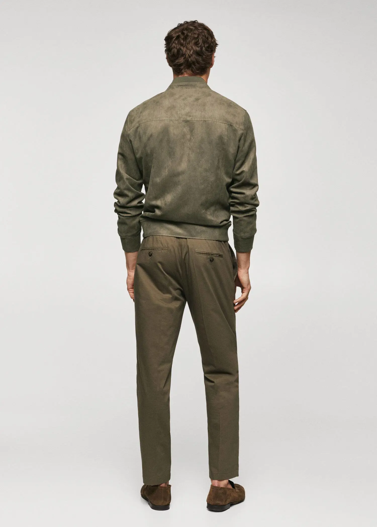 Mango Suede-effect bomber jacket. a man wearing a green jacket and brown pants. 
