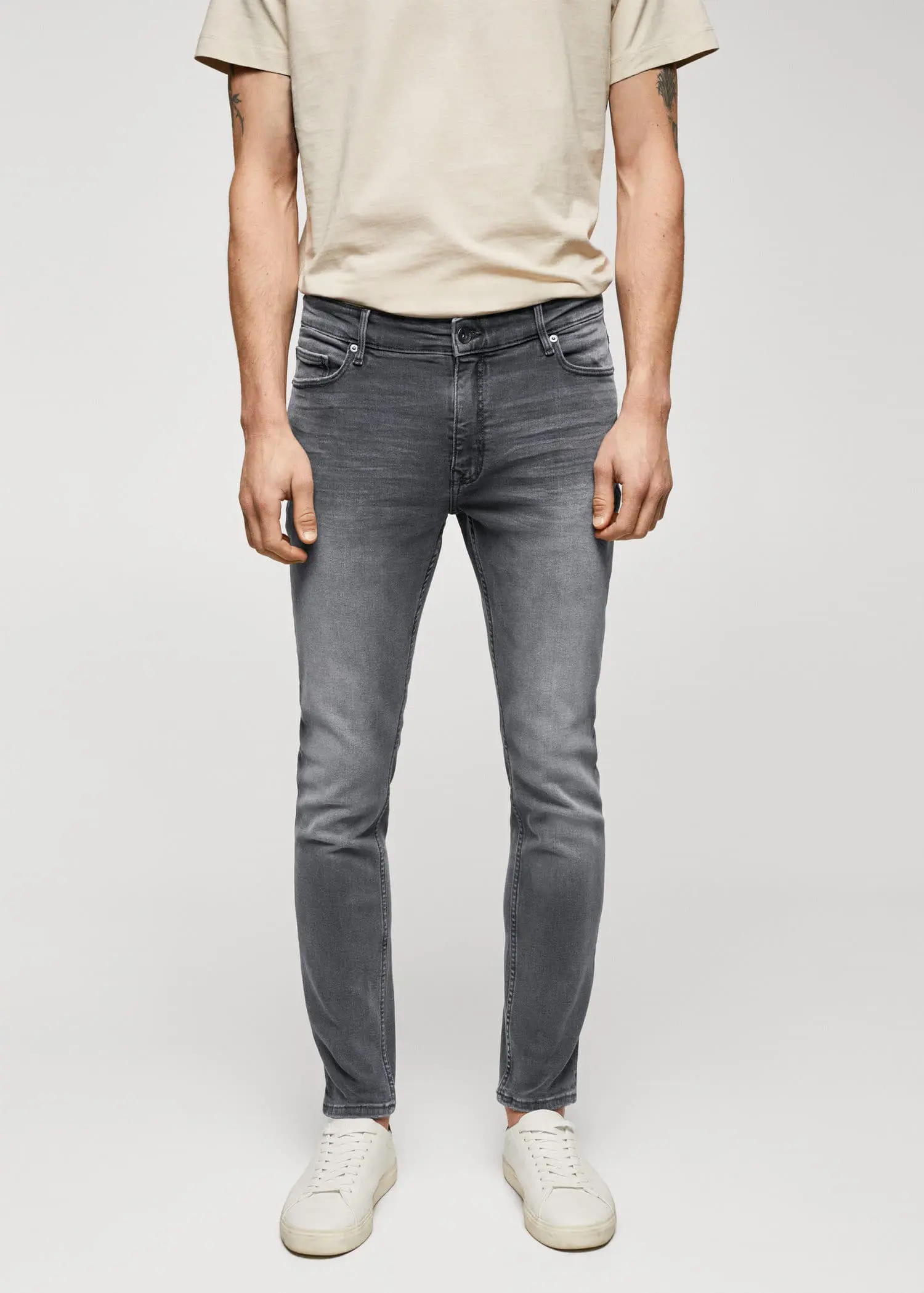 Mango Jude skinny-fit jeans. a man wearing a pair of grey jeans. 