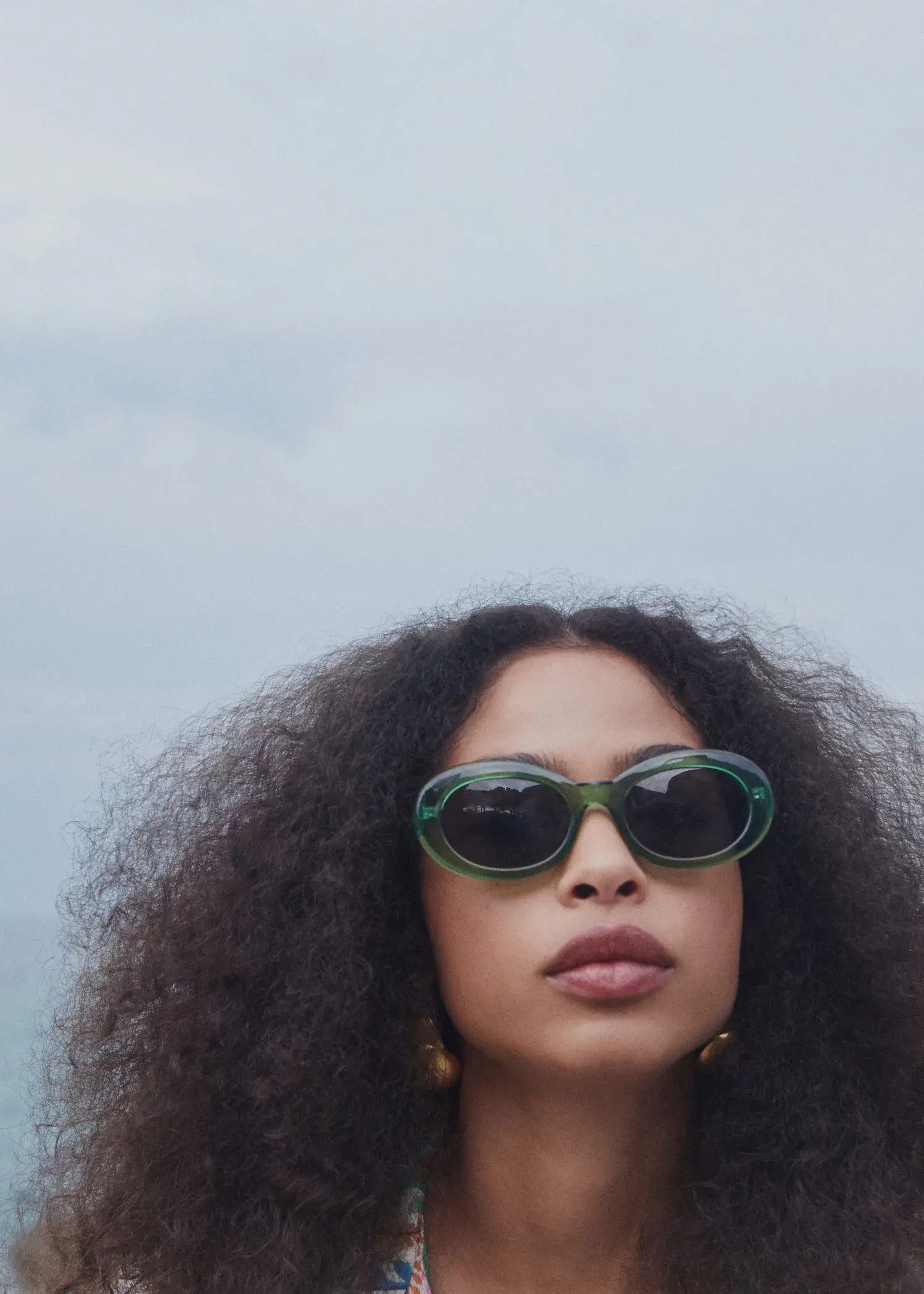 Mango Semi-transparent frame sunglasses. a close up of a person wearing sunglasses 