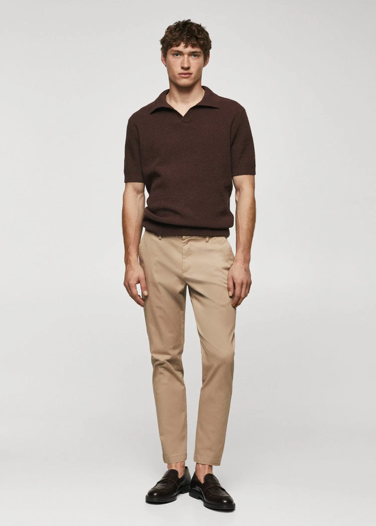 Mango Cotton tapered crop pants. a man in brown shirt and beige pants. 