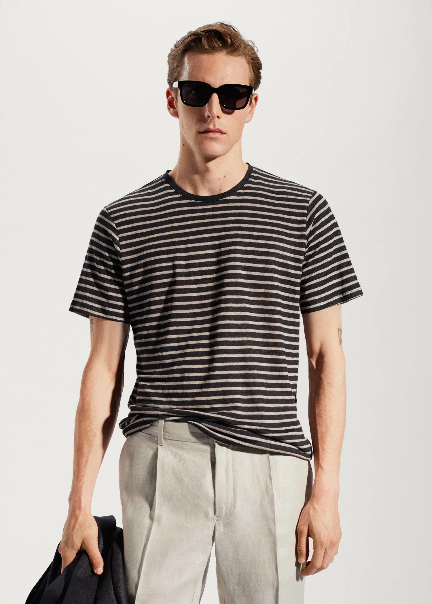 Mango 100% linen striped t-shirt. a man wearing sunglasses and a black and white striped shirt. 