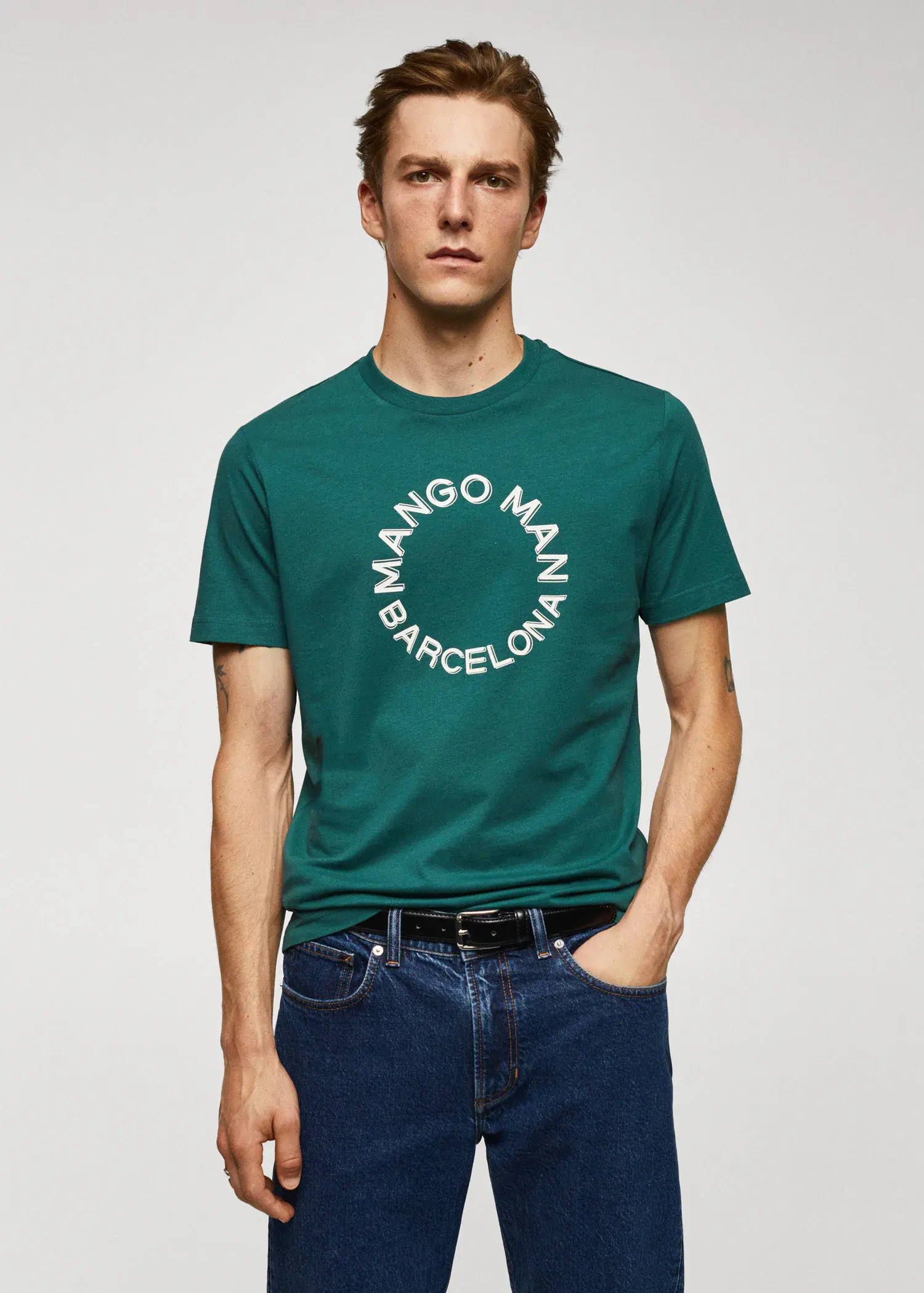 Mango 100% cotton t-shirt with logo. a man wearing a green t-shirt and blue jeans. 