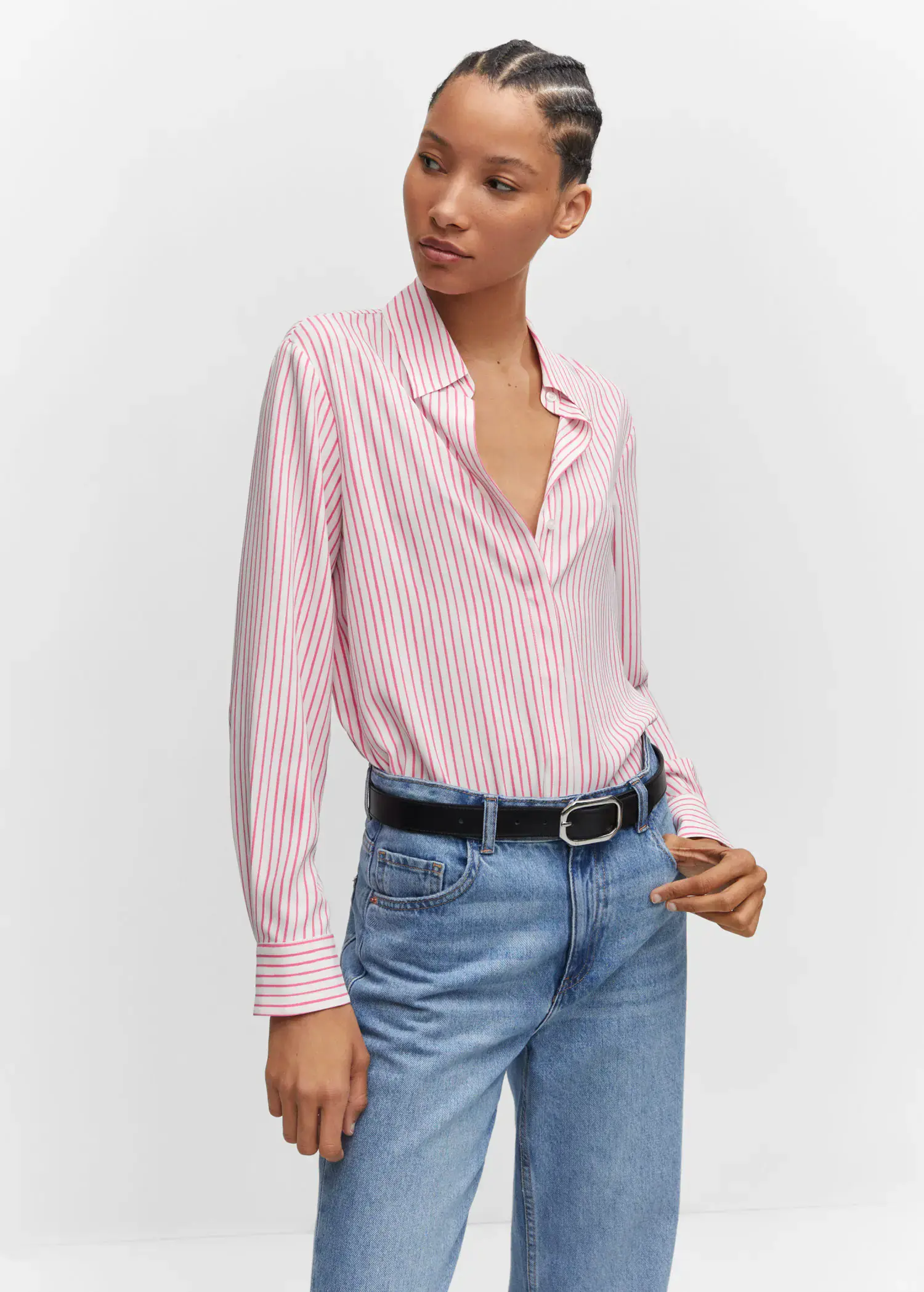 Mango Regular flowy shirt. a woman wearing a pink and white striped shirt and jeans. 