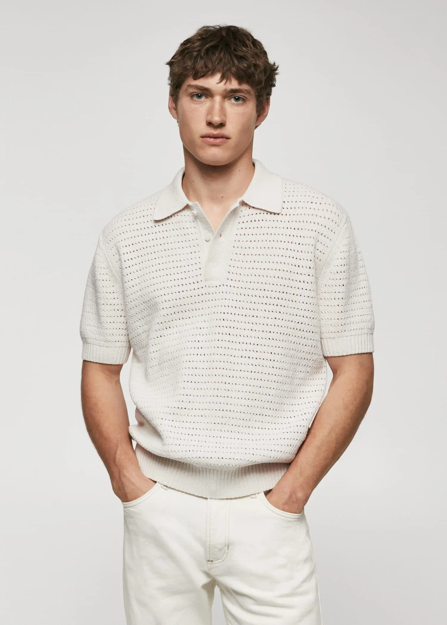 Mango Openwork knit cotton polo. a man in a white shirt and white pants. 