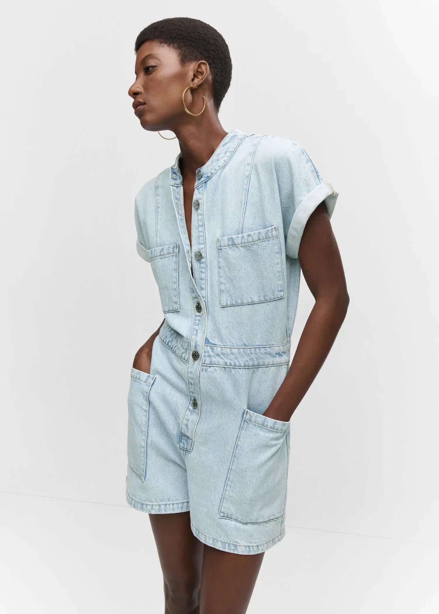 Mango Denim jumpsuit with pockets. a person wearing a light blue denim outfit. 
