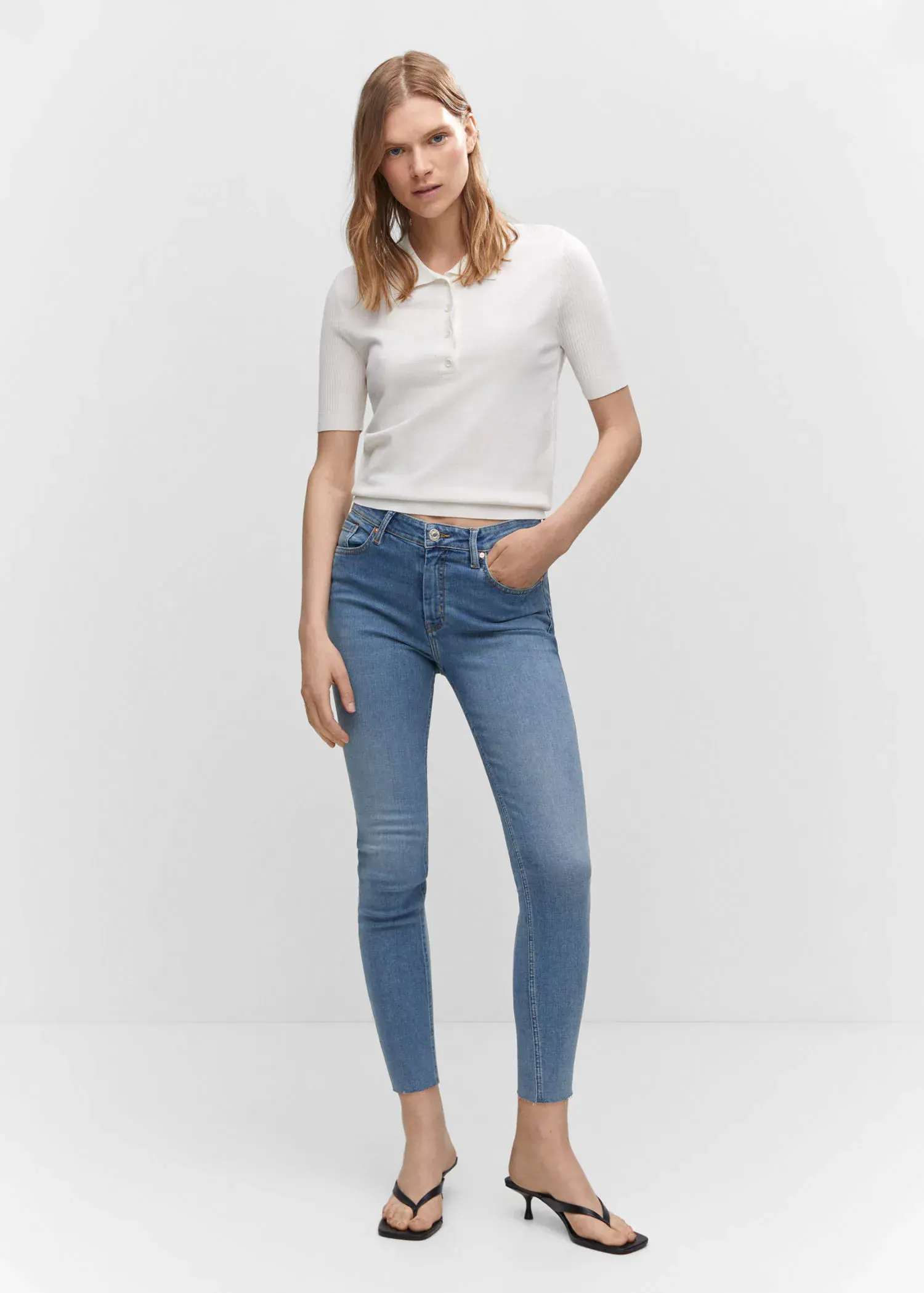 Mango Skinny cropped jeans. a woman in white shirt and blue jeans. 