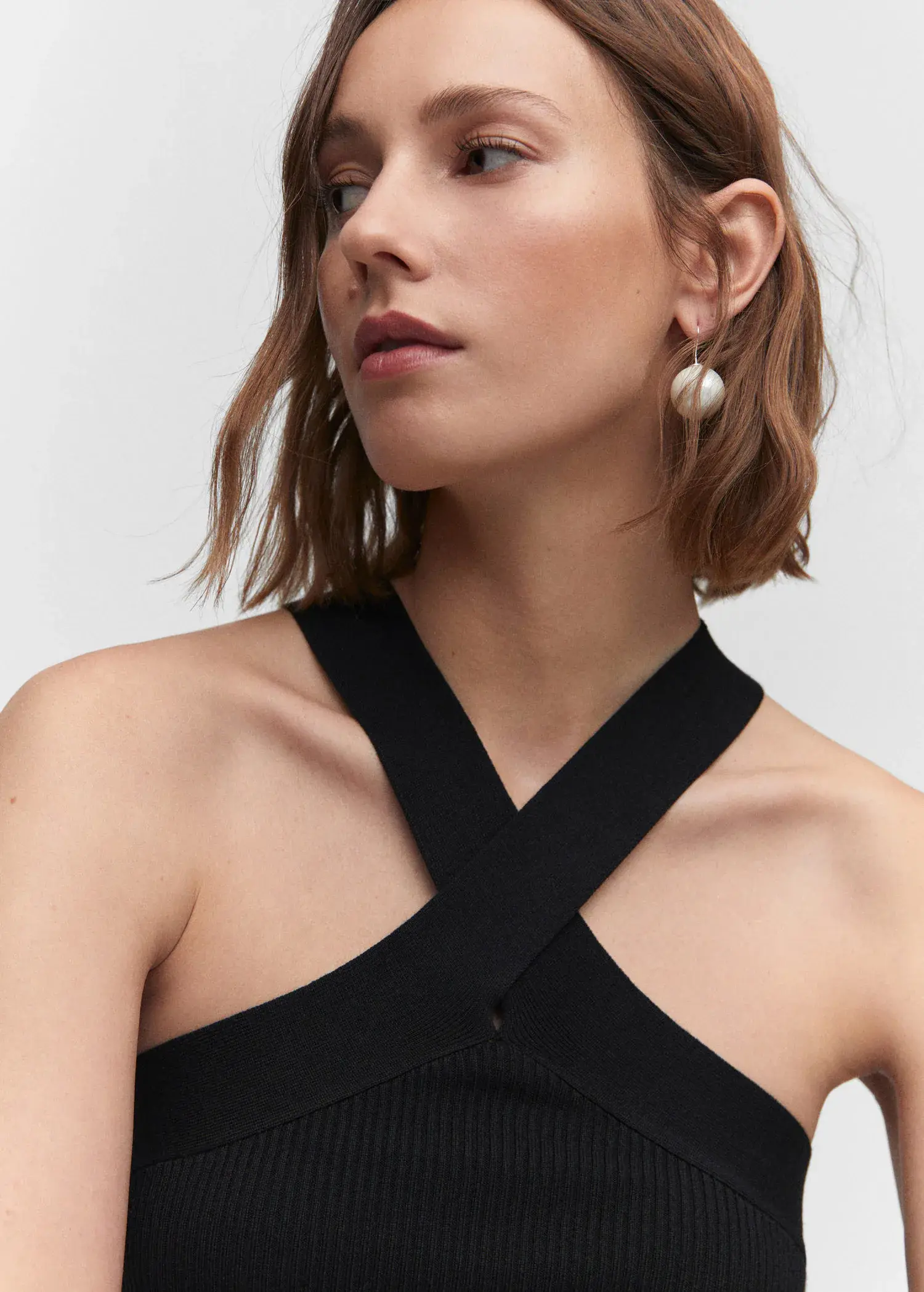 Mango Halter-neck knitted top. a close up of a person wearing a dress 