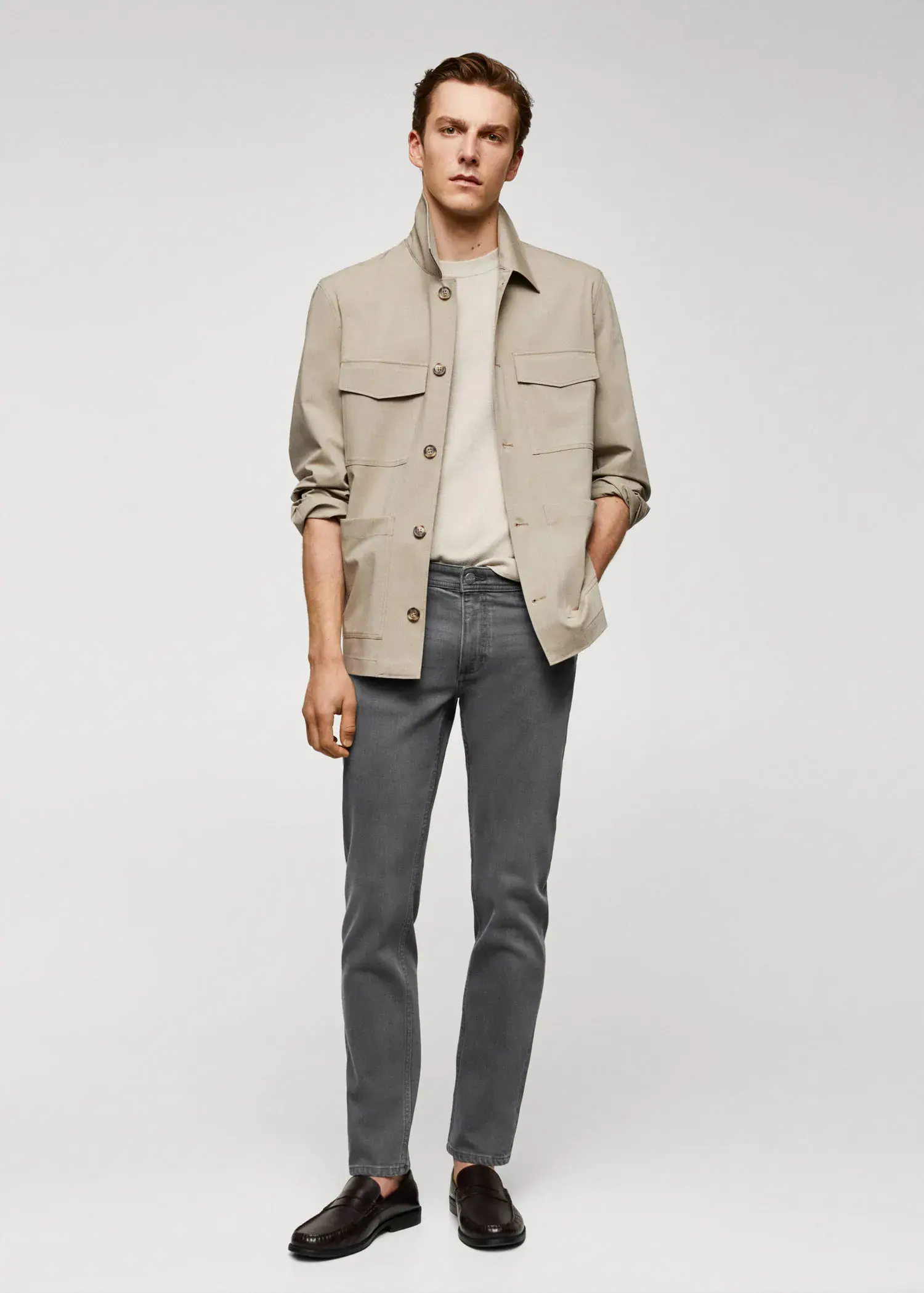 Mango Jan slim-fit jeans. a man in a tan jacket and gray pants. 