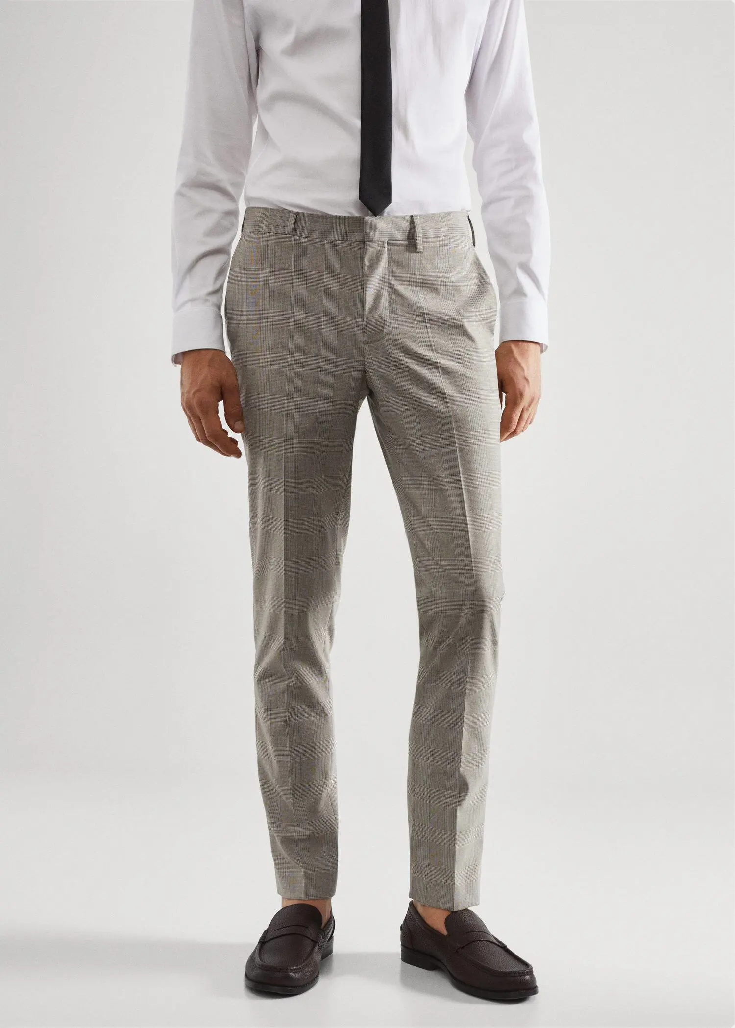 Mango Super slim-fit printed suit trousers. a man wearing a suit and tie standing in front of a white wall. 