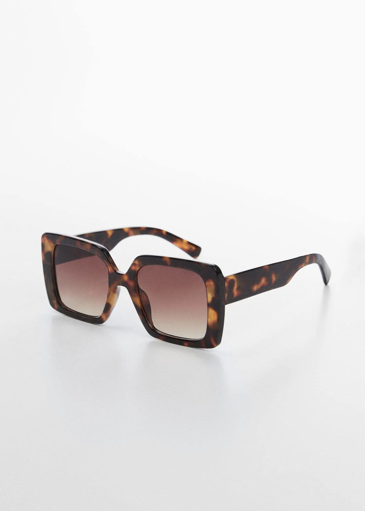 Mango Tortoiseshell square sunglasses. a pair of sunglasses sitting on top of a white table. 