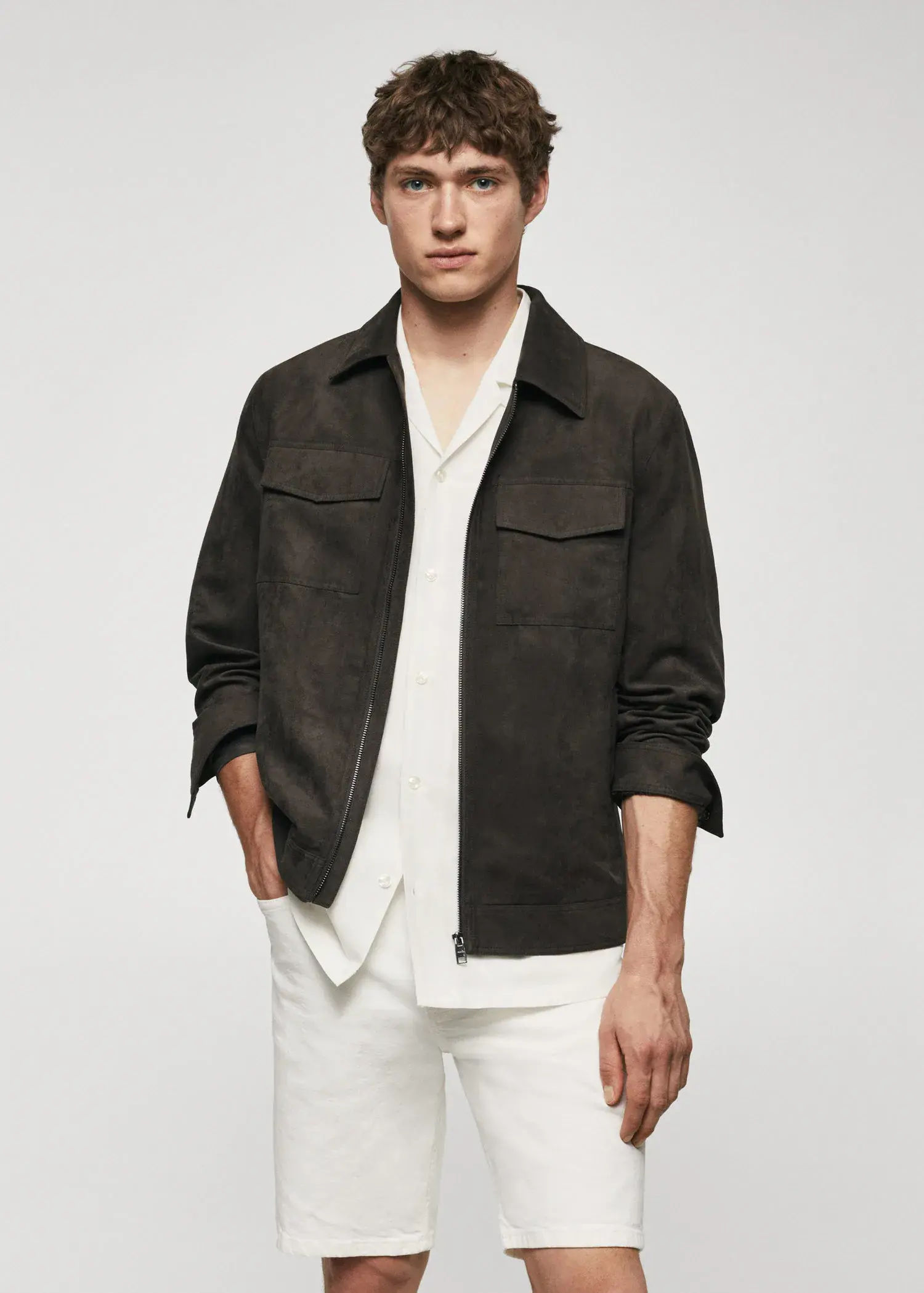Mango Suede effect jacket. a man wearing a black jacket and white pants. 
