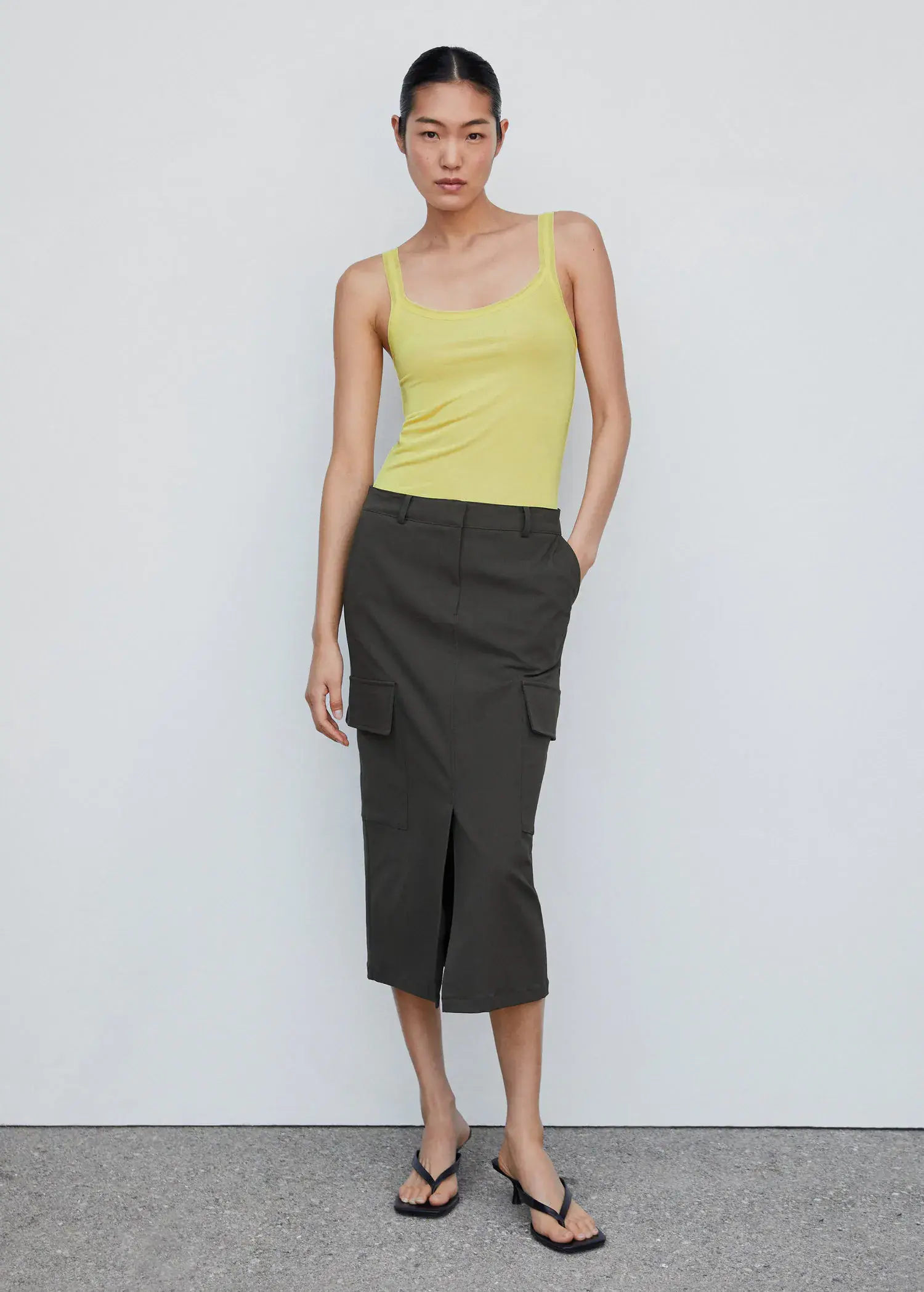 Mango Ribbed strap top. a woman in a yellow shirt and a black skirt 