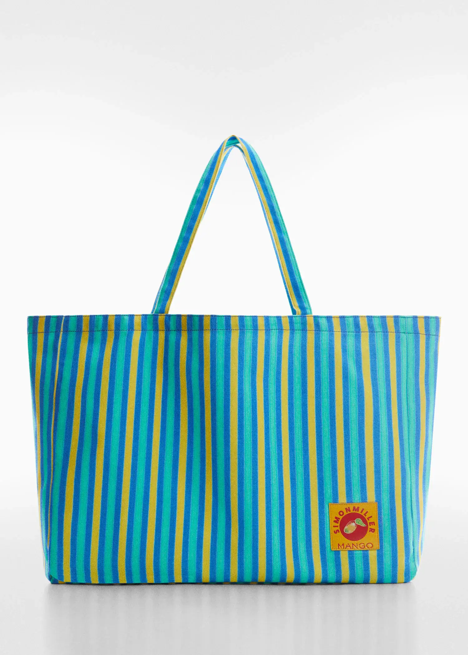 Mango Multi-colored striped maxi bag. a blue and yellow striped tote bag with a lion patch on it. 