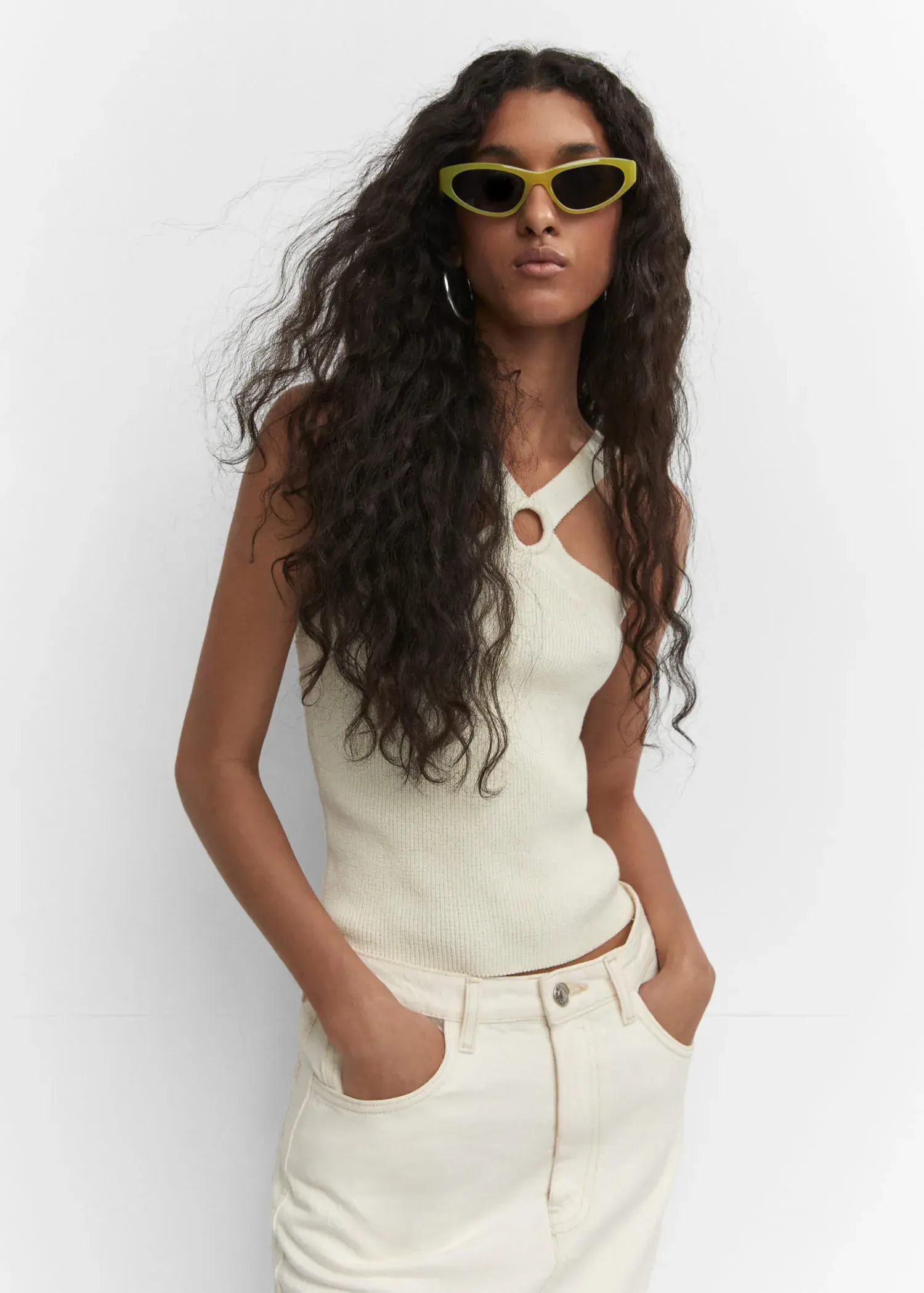 Mango Retro style sunglasses. a woman with long curly hair wearing sunglasses. 