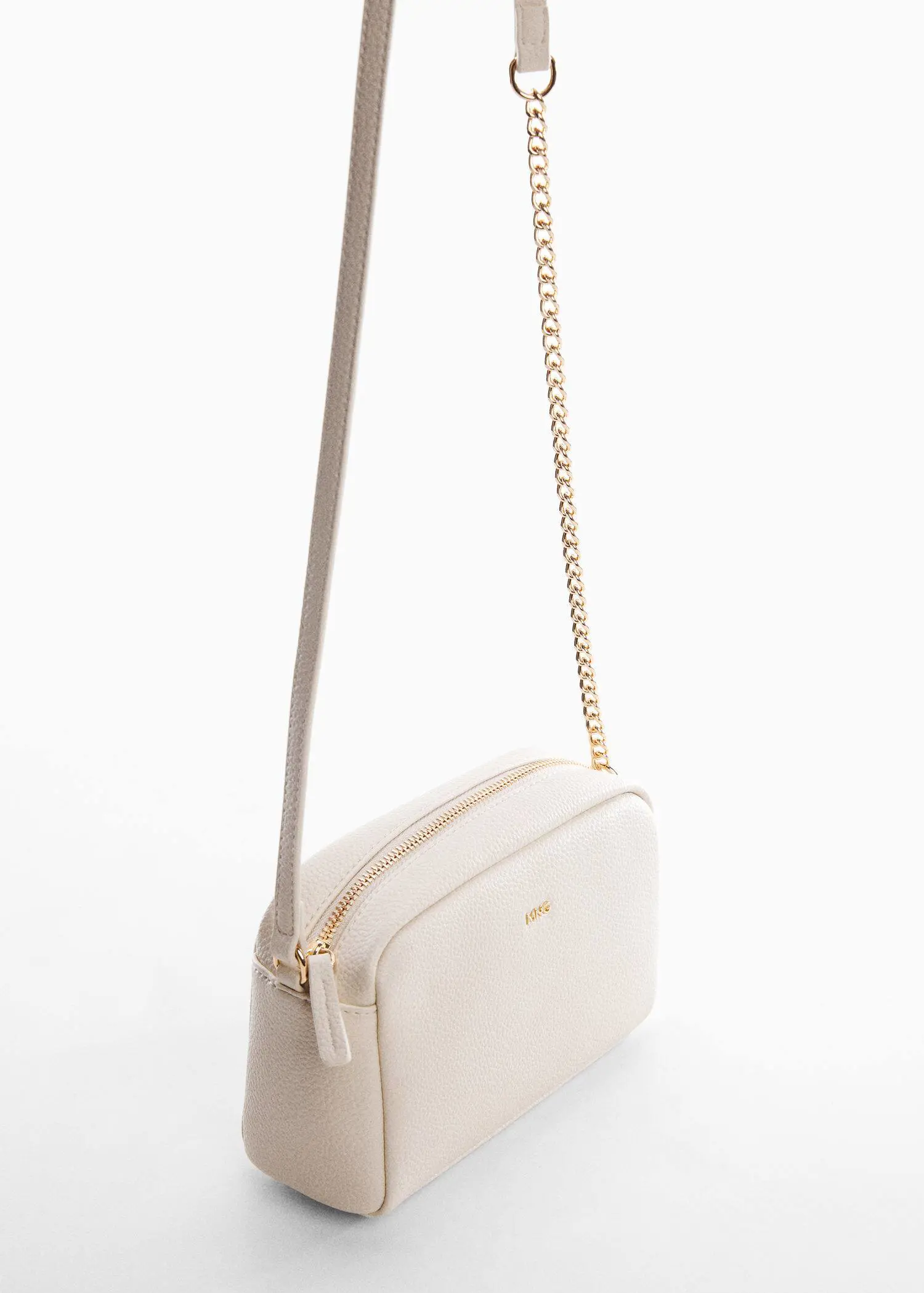 Mango Crossbody bag with chain. a close up of a white purse on a white surface 