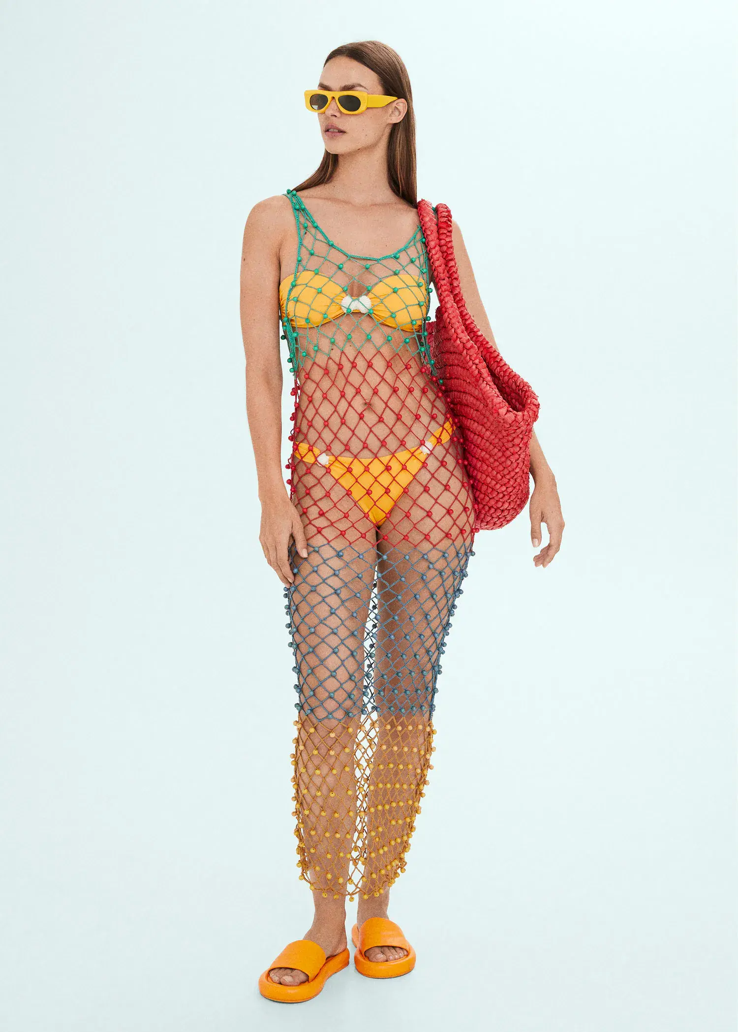 Mango Multi-colored net dress with beads. a woman in a colorful bikini and fishnet suit. 