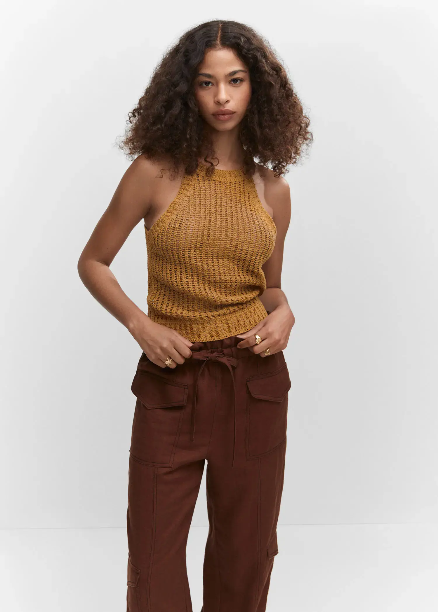 Mango Halter-neck knitted top. a woman in a brown outfit is posing. 