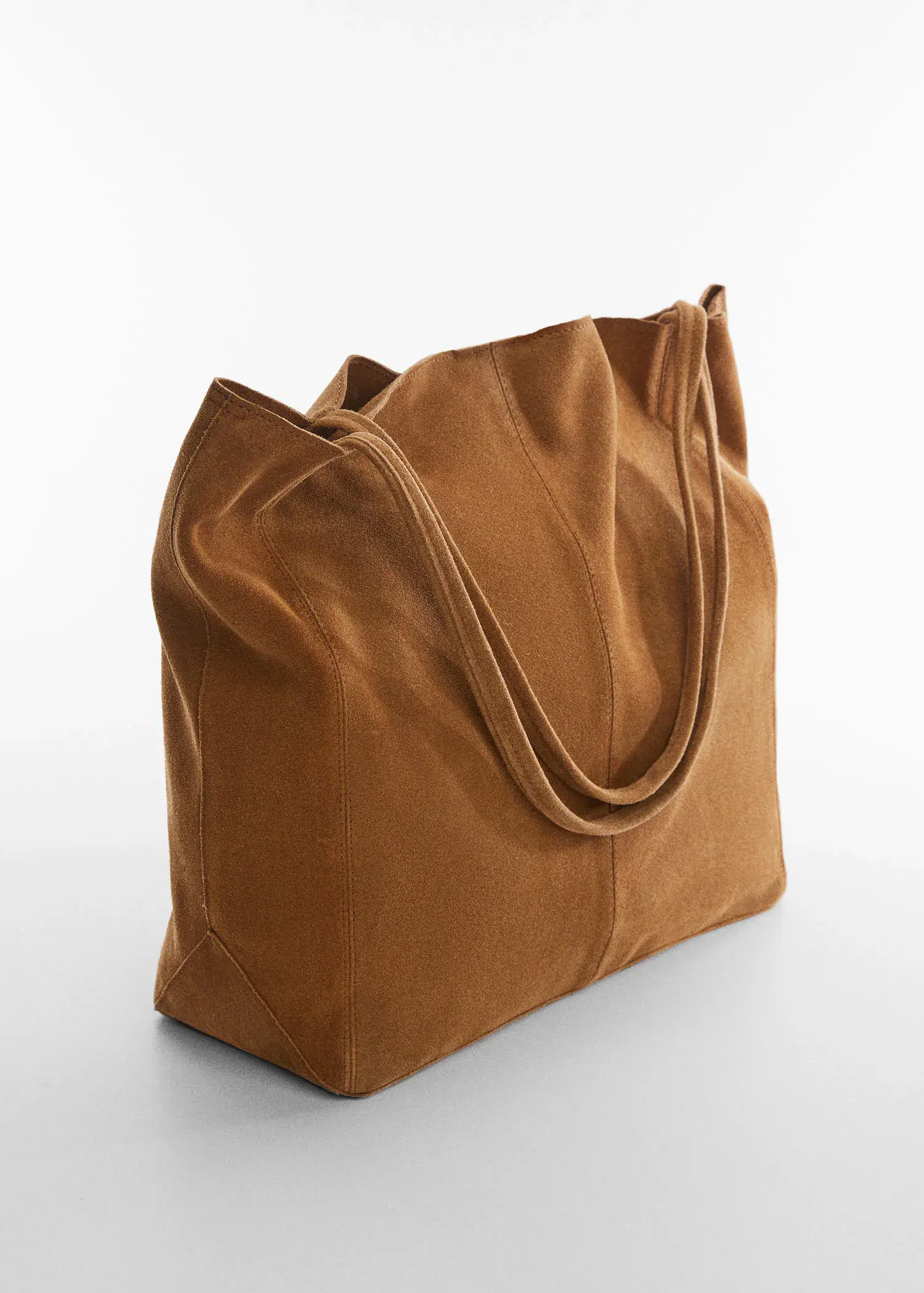 Mango Leather shopper bag. a brown bag sitting on top of a white table. 
