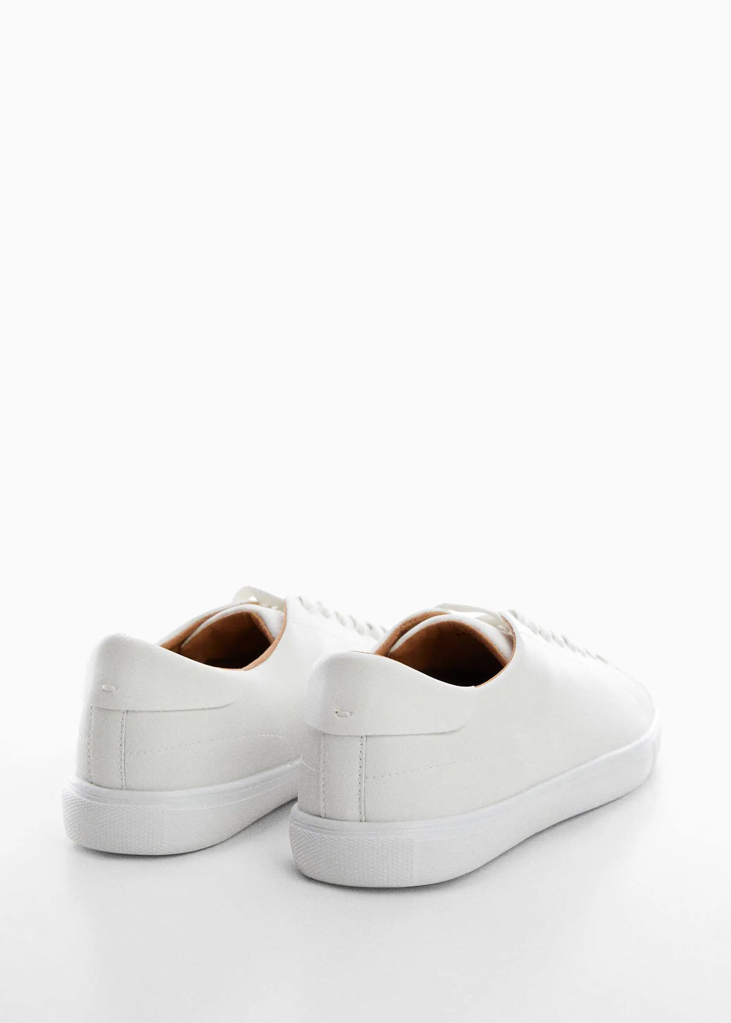 Mango Monocoloured leather sneakers. a pair of white sneakers on a white surface. 