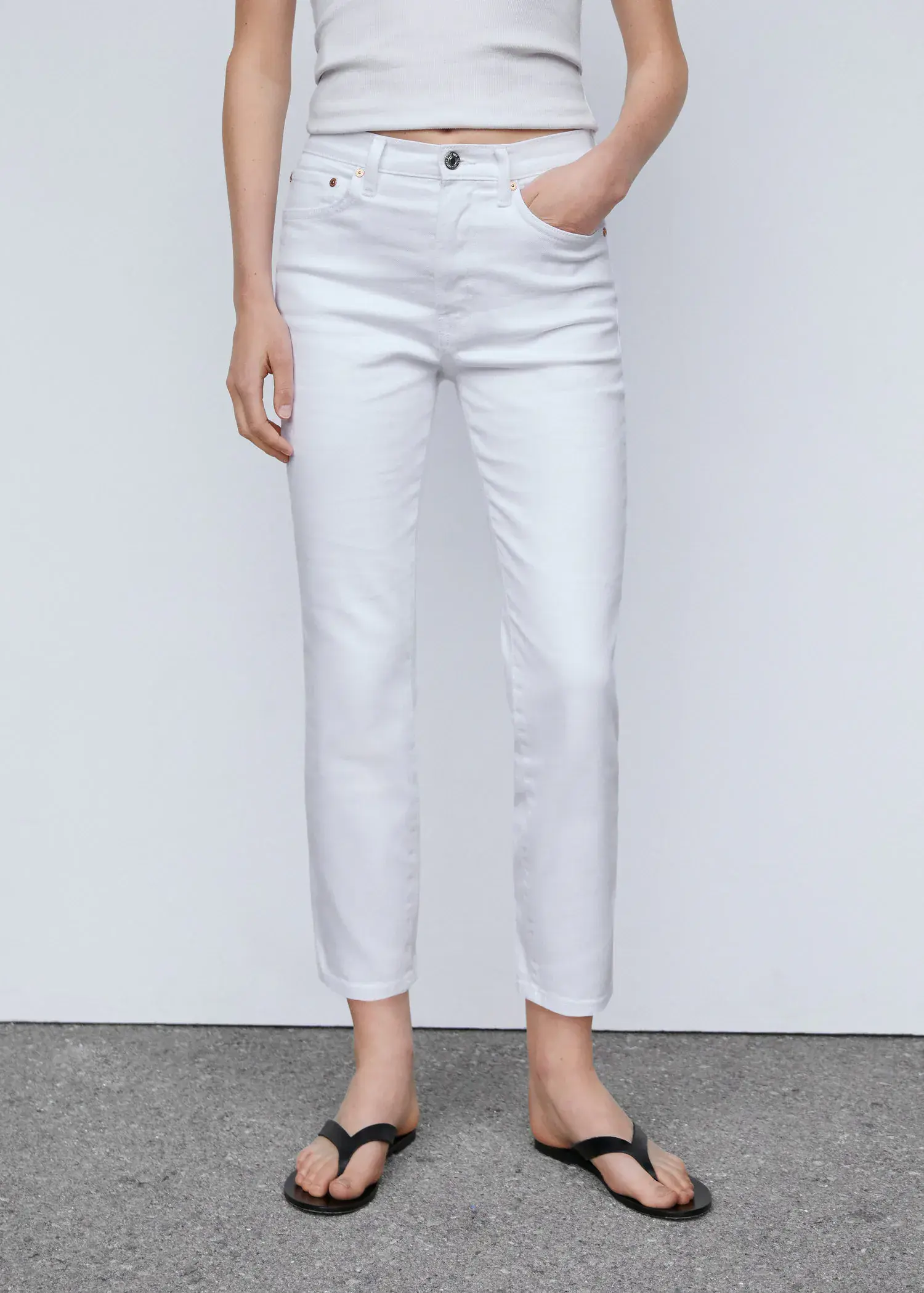 Mango Slim cropped jeans. a person wearing white jeans and a white shirt. 