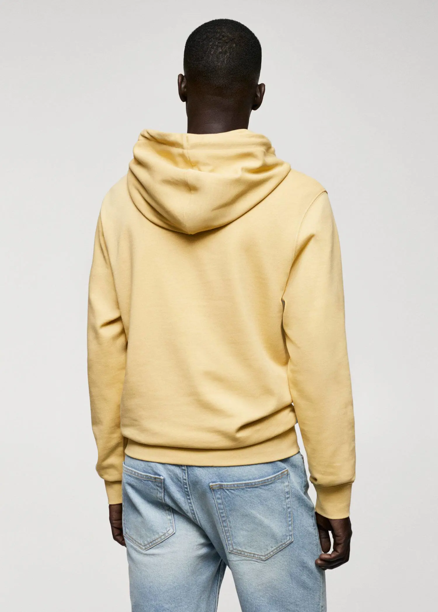 Mango Hoodie cotton sweatshirt. a person wearing a yellow hoodie and jeans. 
