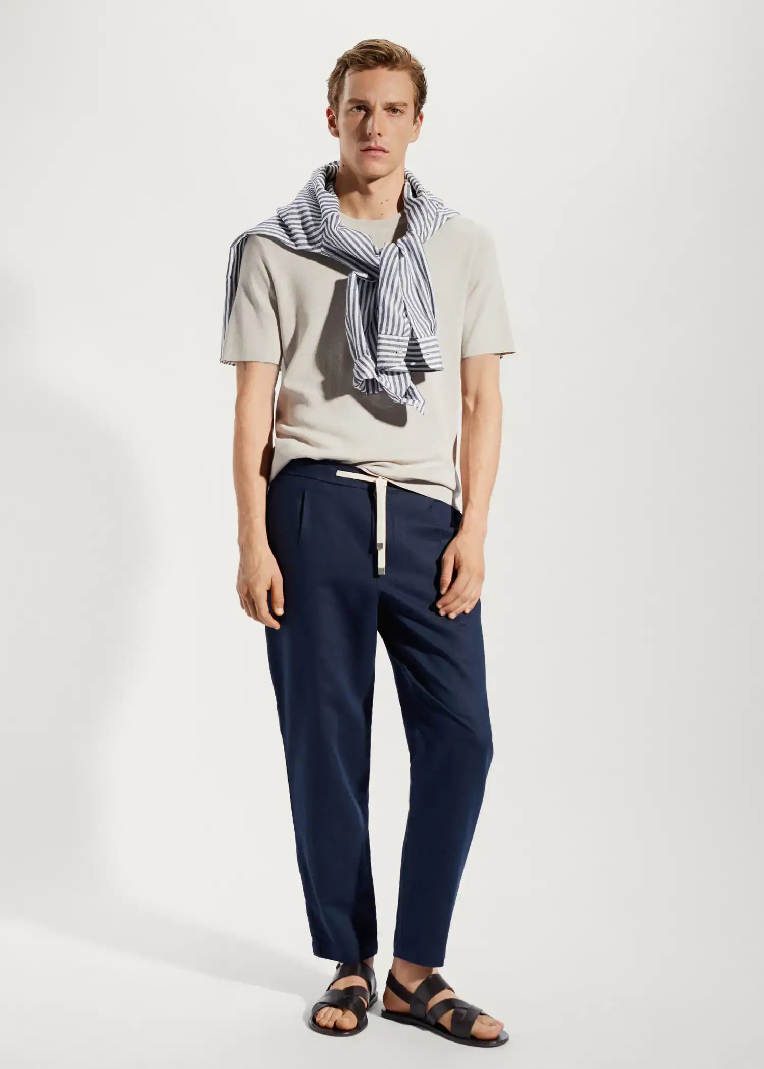 Mango Slim-fit pants with drawstring . a man in a white shirt and blue pants. 