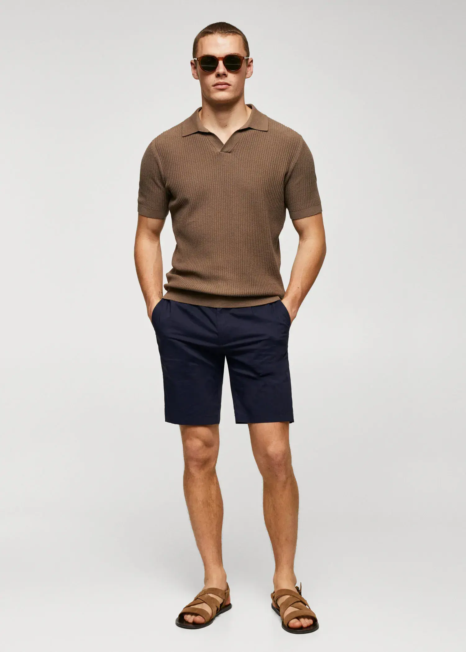 Mango Cotton pleated Bermuda shorts. a man in a brown polo shirt and blue shorts. 