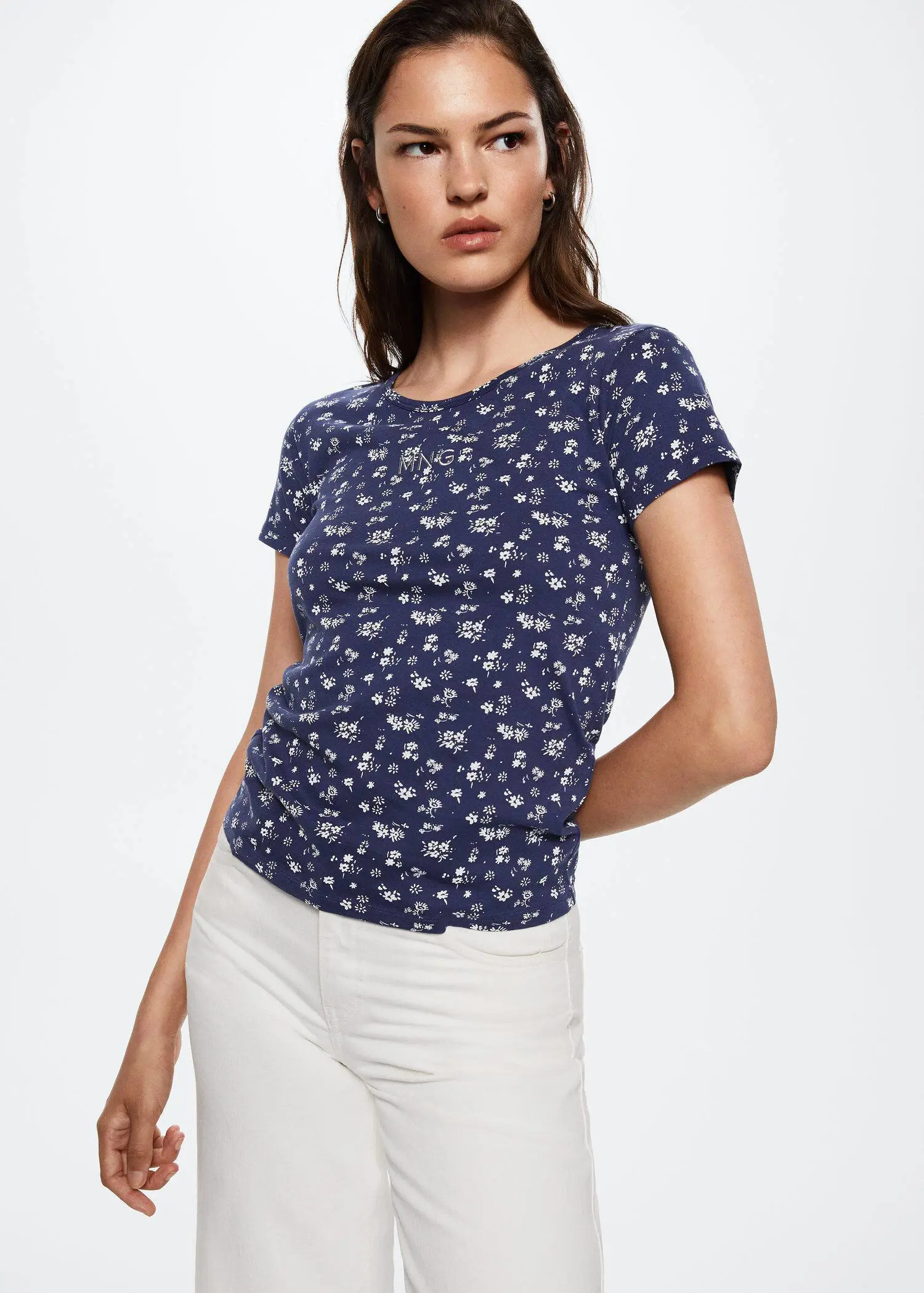 Mango Printed cotton-blend T-shirt. a woman wearing white pants and a blue top. 