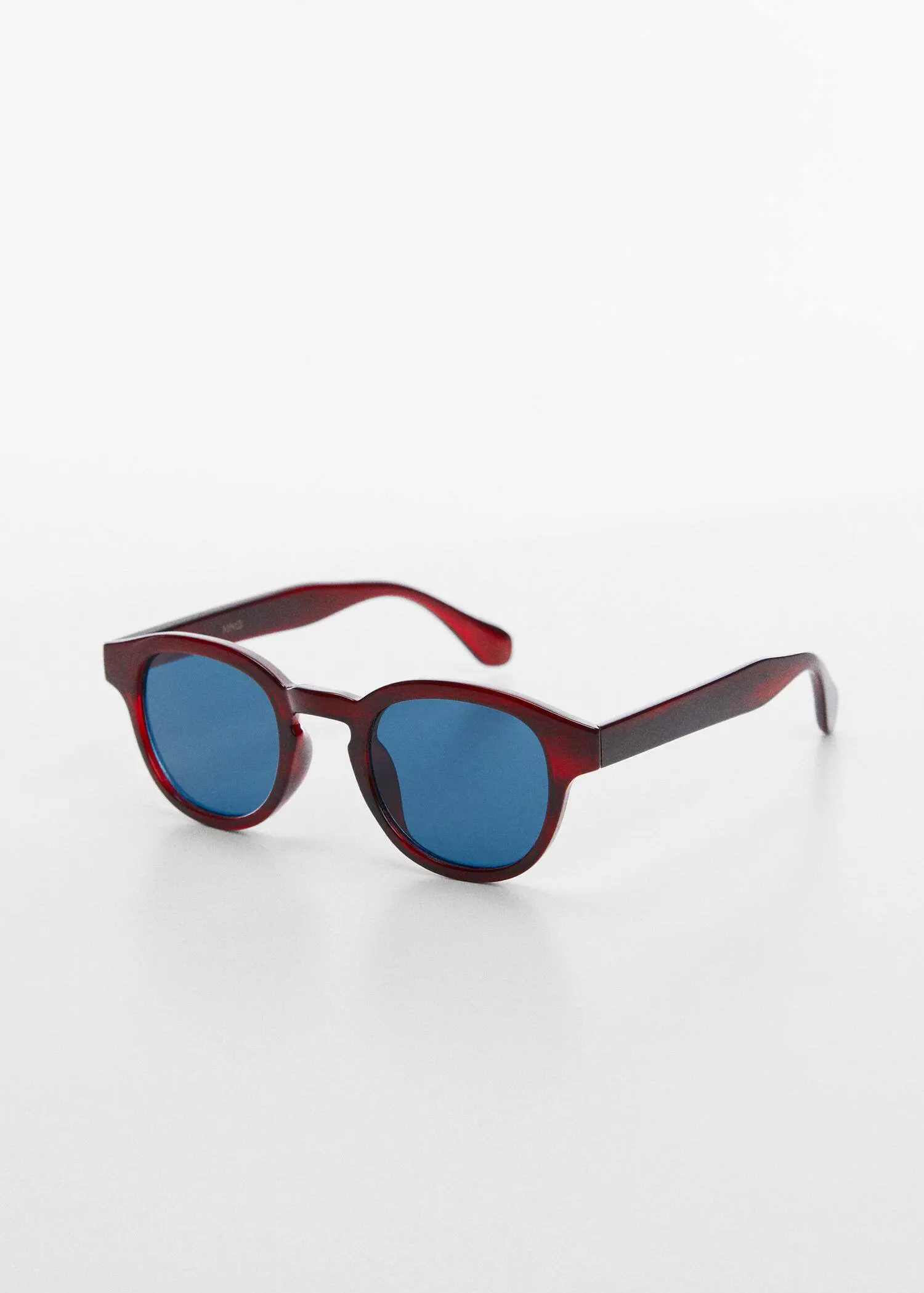 Mango Rounded sunglasses. a pair of red sunglasses on a white surface. 
