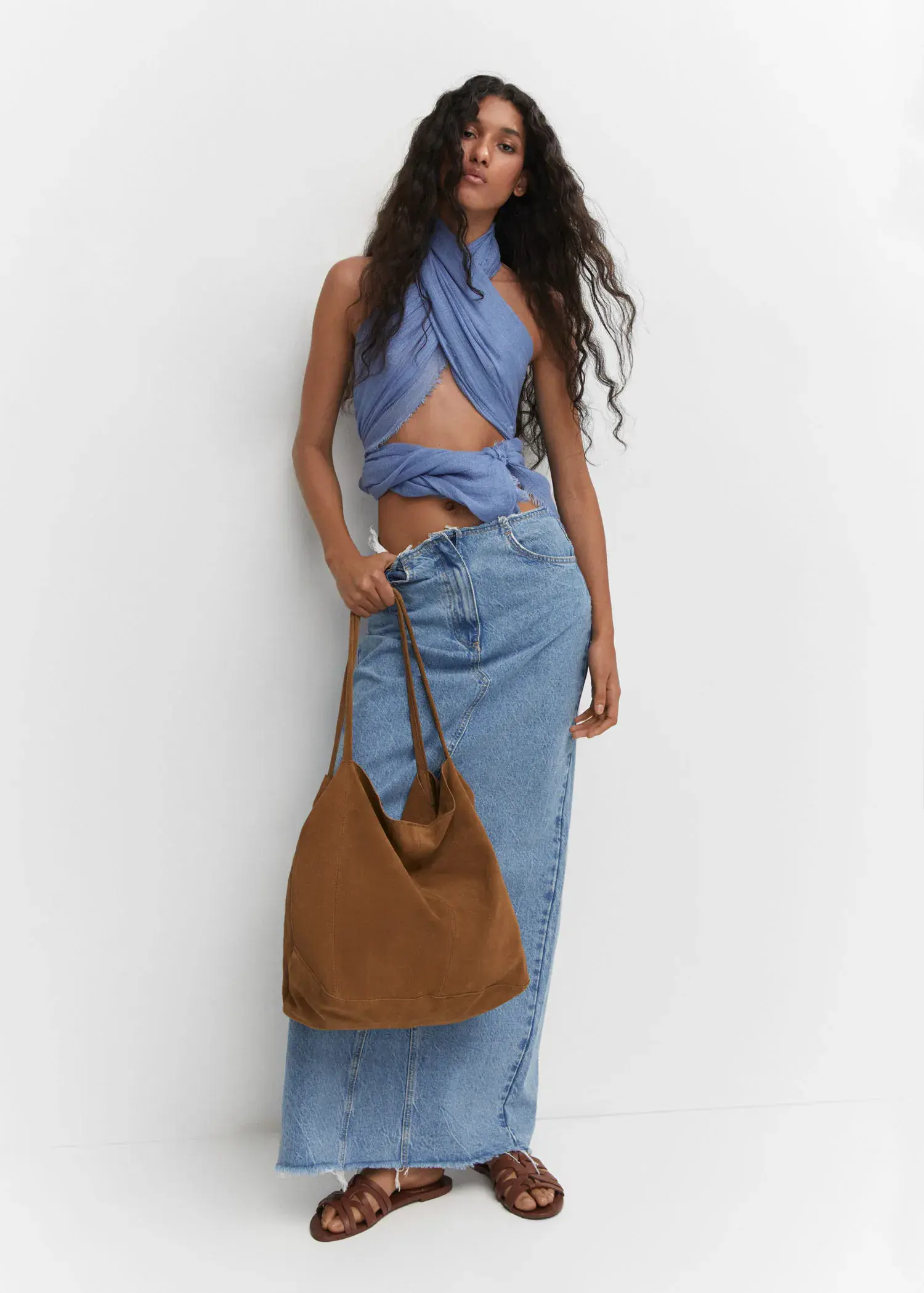 Mango Leather shopper bag. a woman standing in front of a white wall holding a bag. 