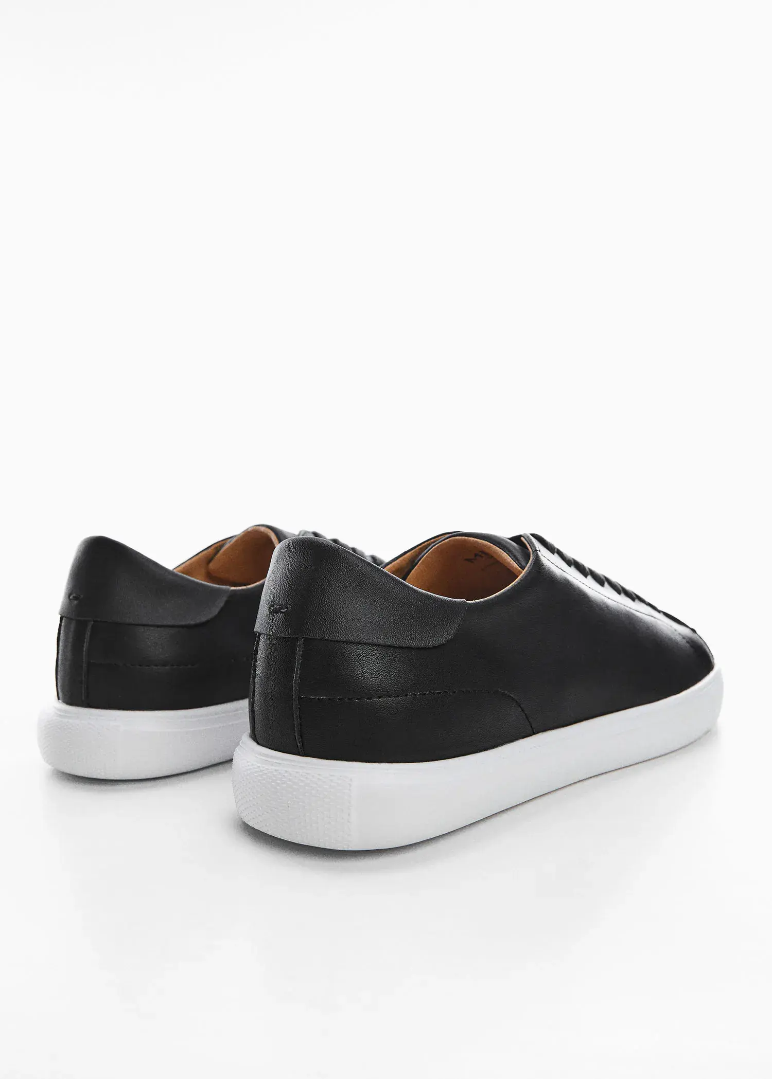 Mango Monocoloured leather sneakers. a pair of black sneakers on a white surface. 