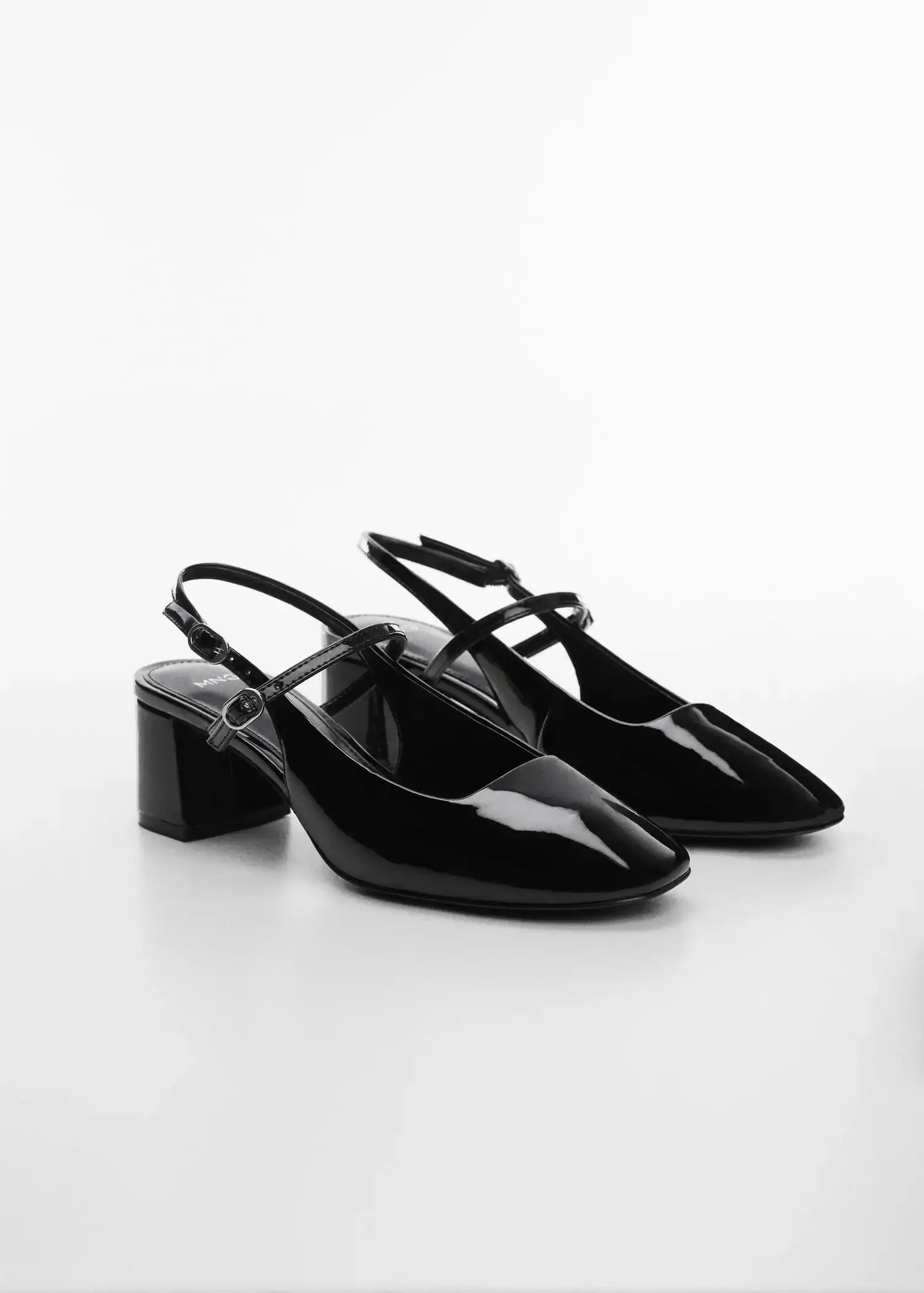Mango Block heel shoe. a pair of black shoes sitting on top of a table. 