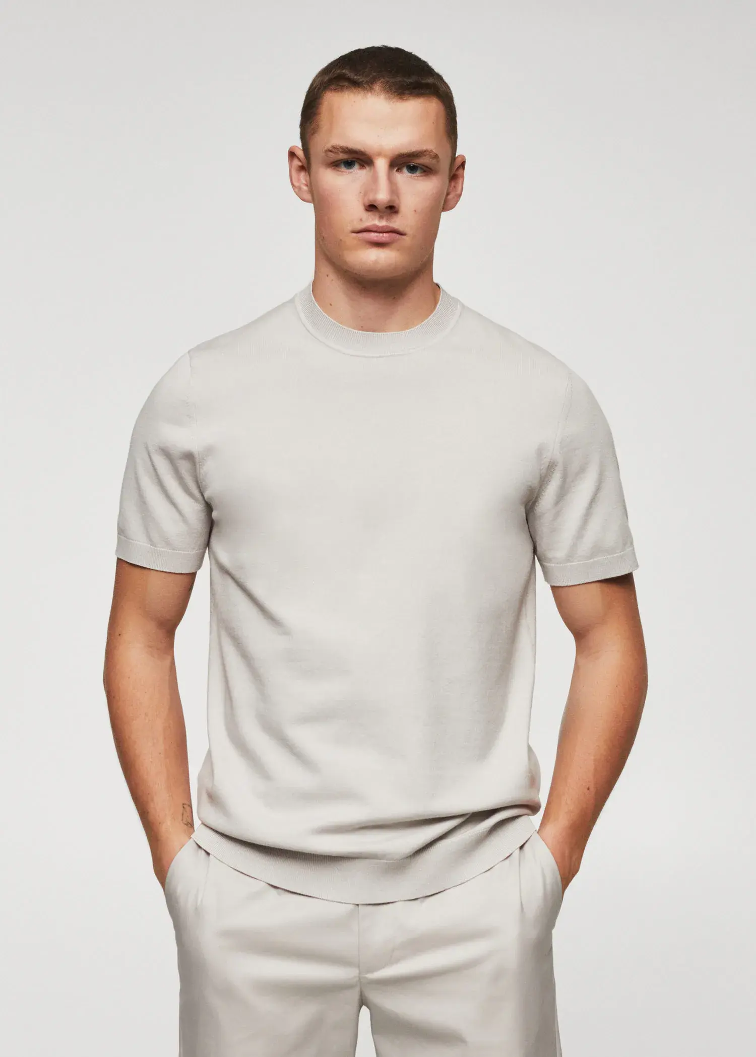 Mango Fine-knit T-shirt. a man in a white shirt is posing for a picture. 