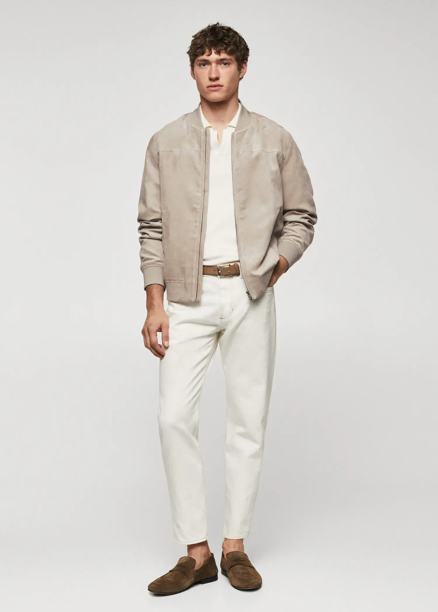 Mango Suede-effect bomber jacket. a man in a tan jacket and white pants. 