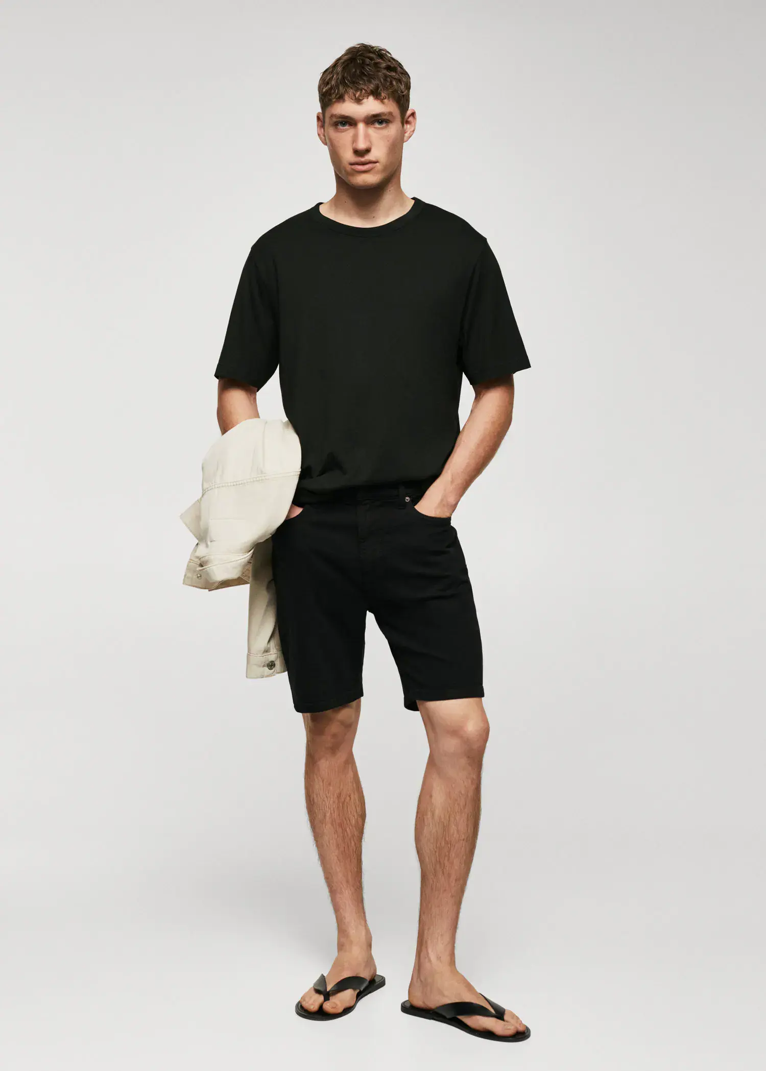 Mango Basic mercerized lightweight shirt. a man in black shirt and black shorts. 