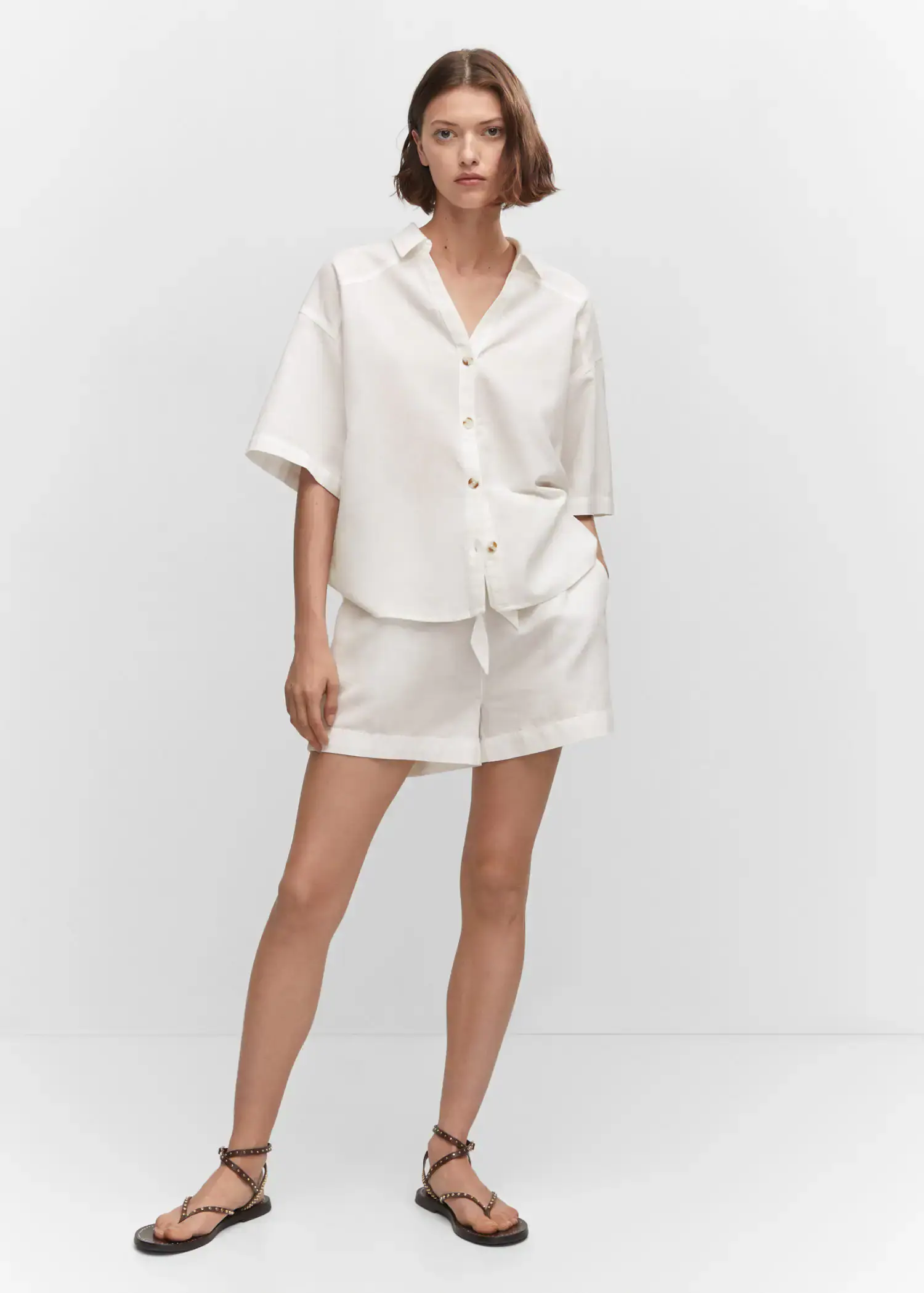 Mango Cotton linen-blend shirt. a woman in white shorts and a white shirt. 