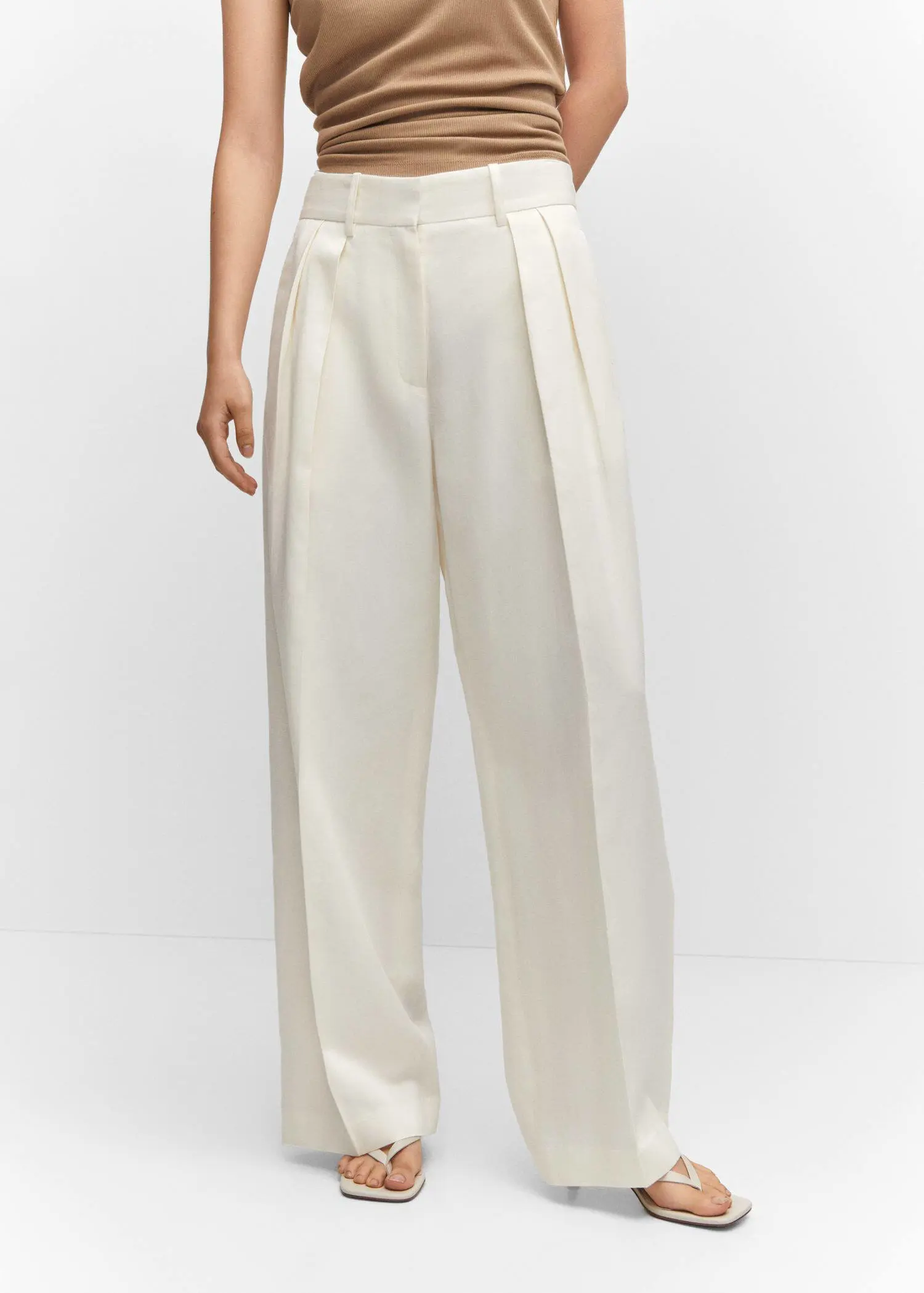 Mango Wideleg pleated pants. a person wearing white pants and a white top. 