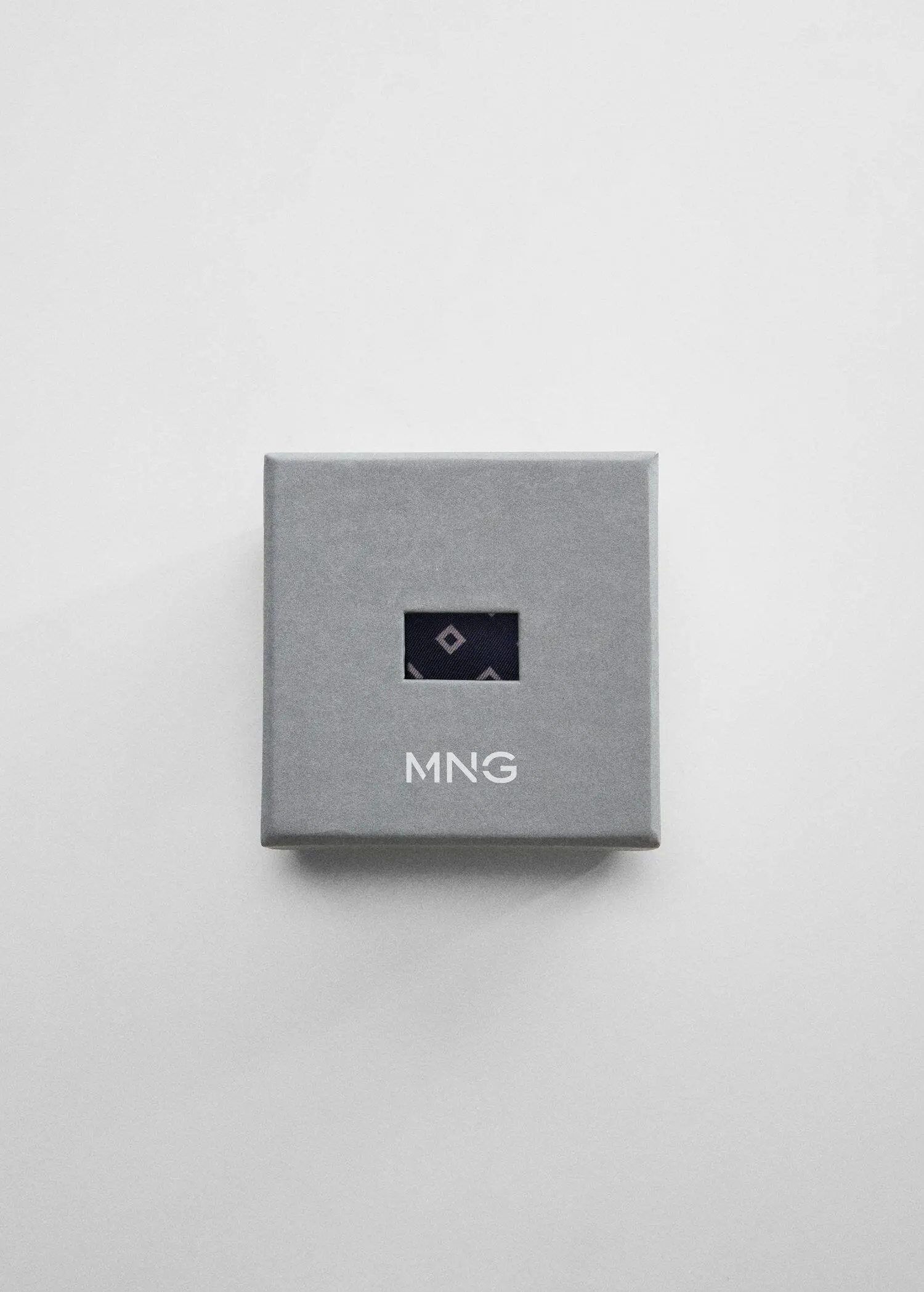 Mango Printed pocket square. a gray box with the word mng on it. 