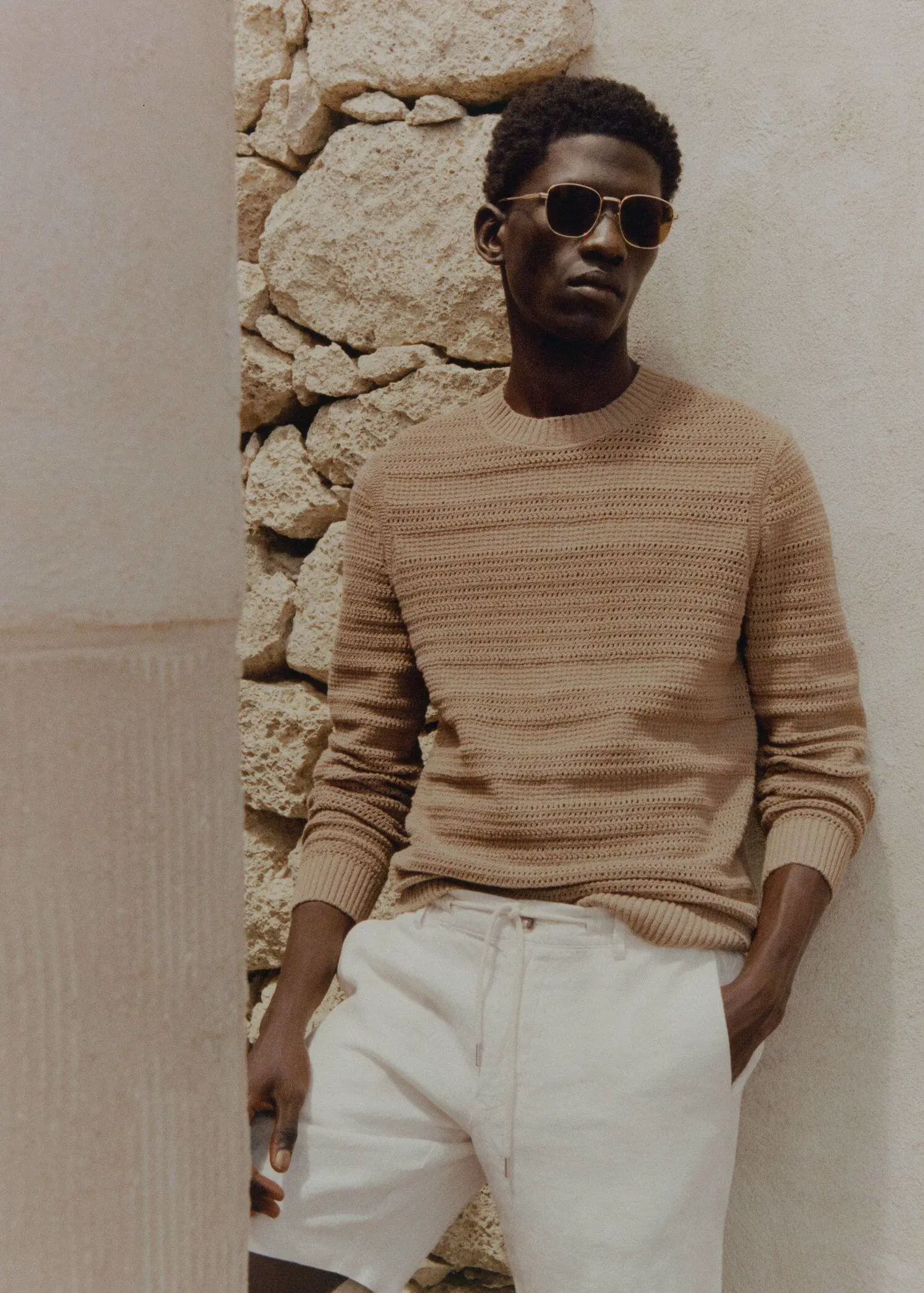 Mango Openwork cotton sweater. a man in a tan sweater and white pants. 