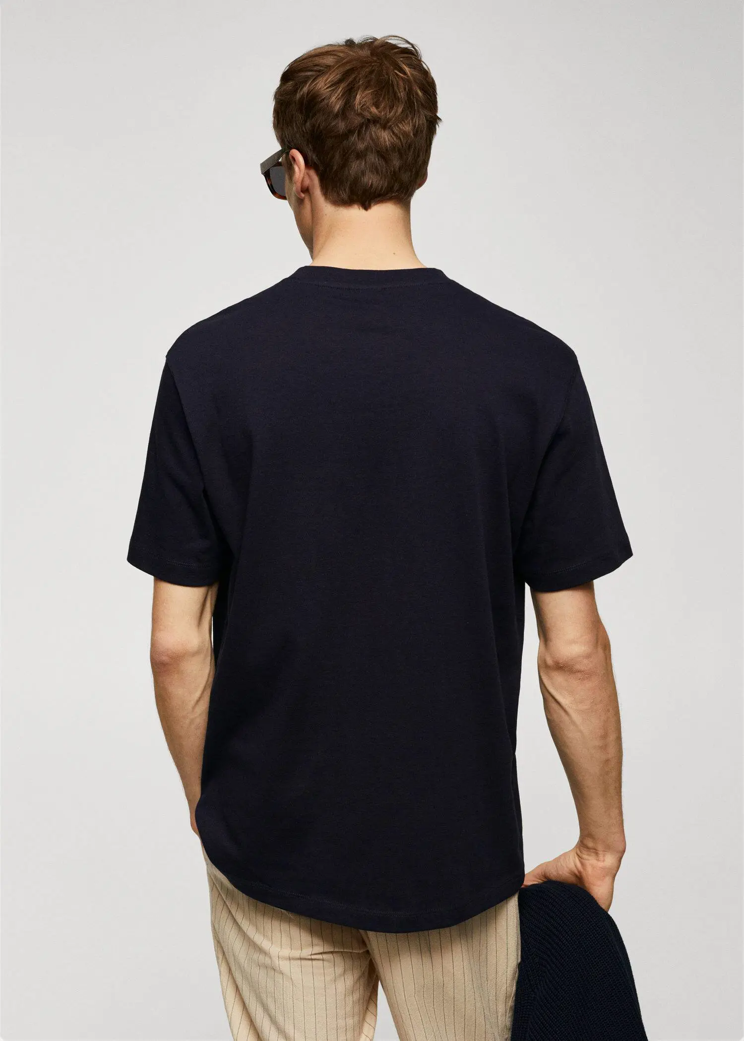 Mango Basic 100% cotton relaxed-fit t-shirt. a man in a black shirt and sunglasses. 