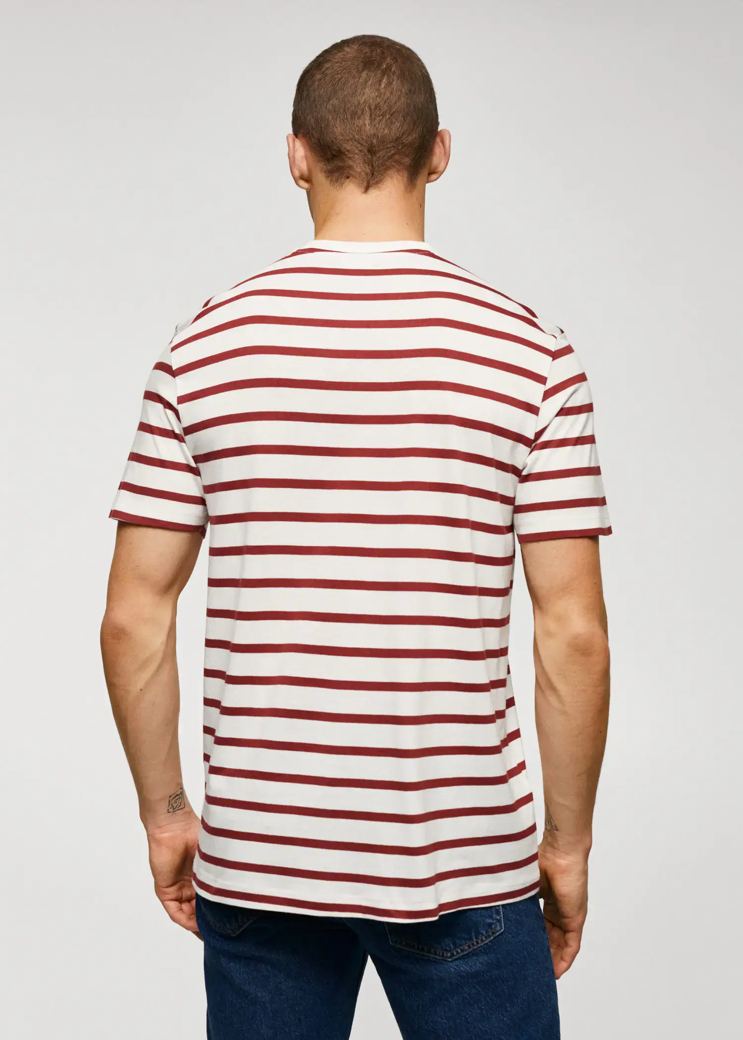 Mango Cotton-modal striped t-shirt. a man in a striped shirt is looking down. 