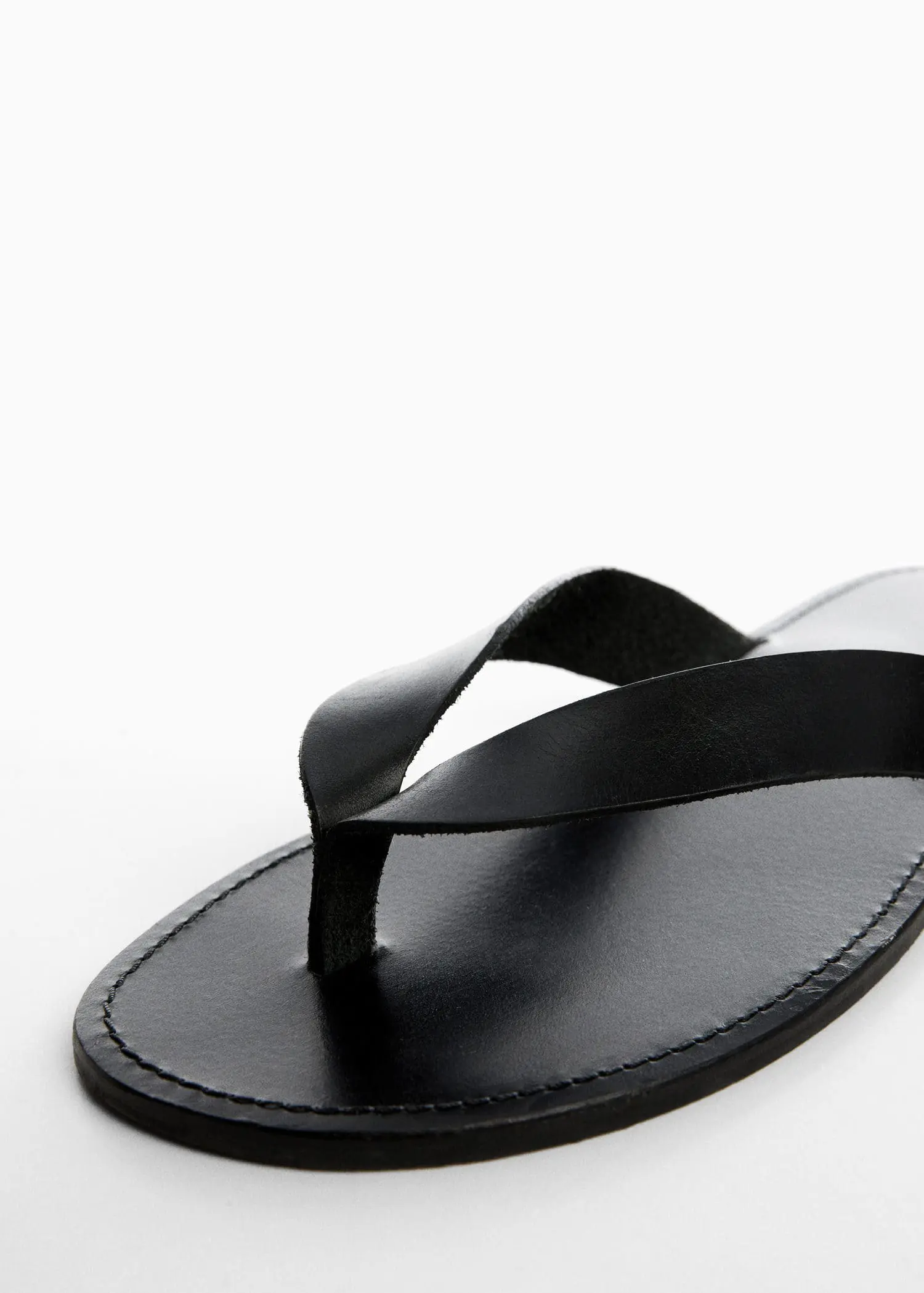 Mango Leather straps sandals. a pair of flip flops sitting on top of a white surface. 