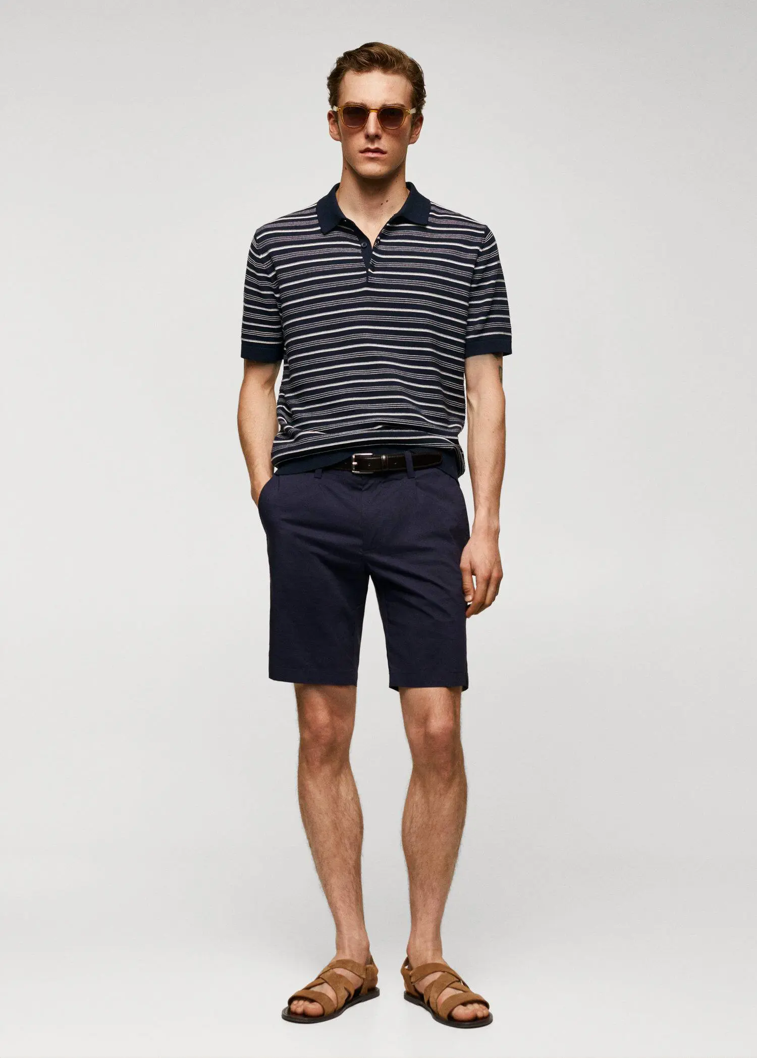 Mango Striped fine-knit polo shirt. a man in a striped polo shirt and shorts. 