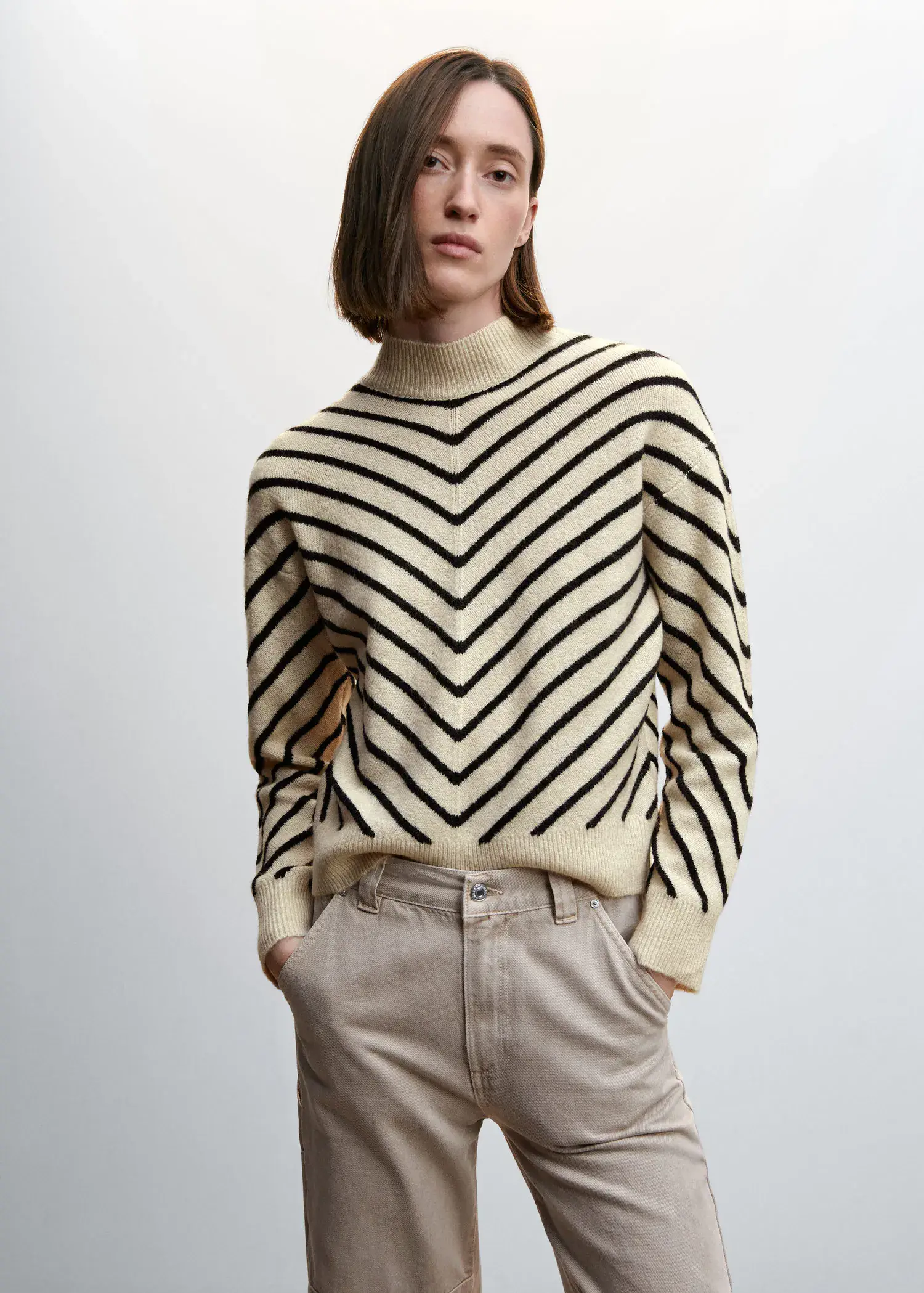 Mango Stripe-print sweater with Perkins neck. a woman in a striped sweater standing with her hands in her pockets. 