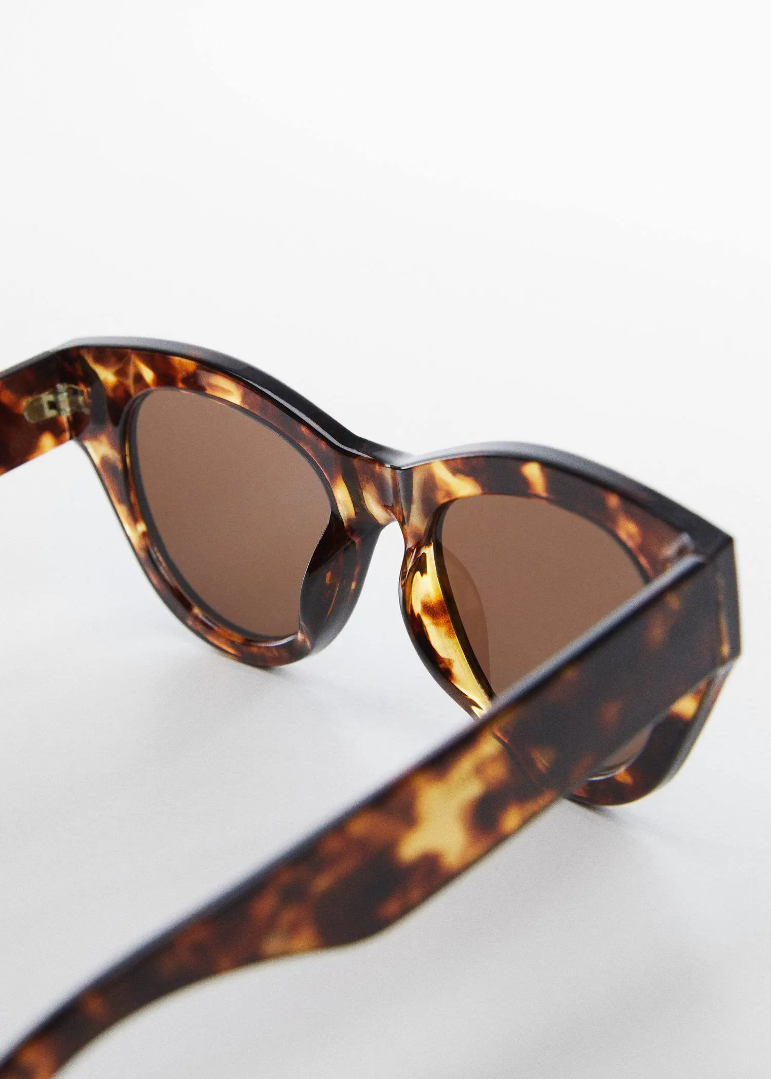 Mango Rounded sunglasses. a close up of a pair of sunglasses on a table 