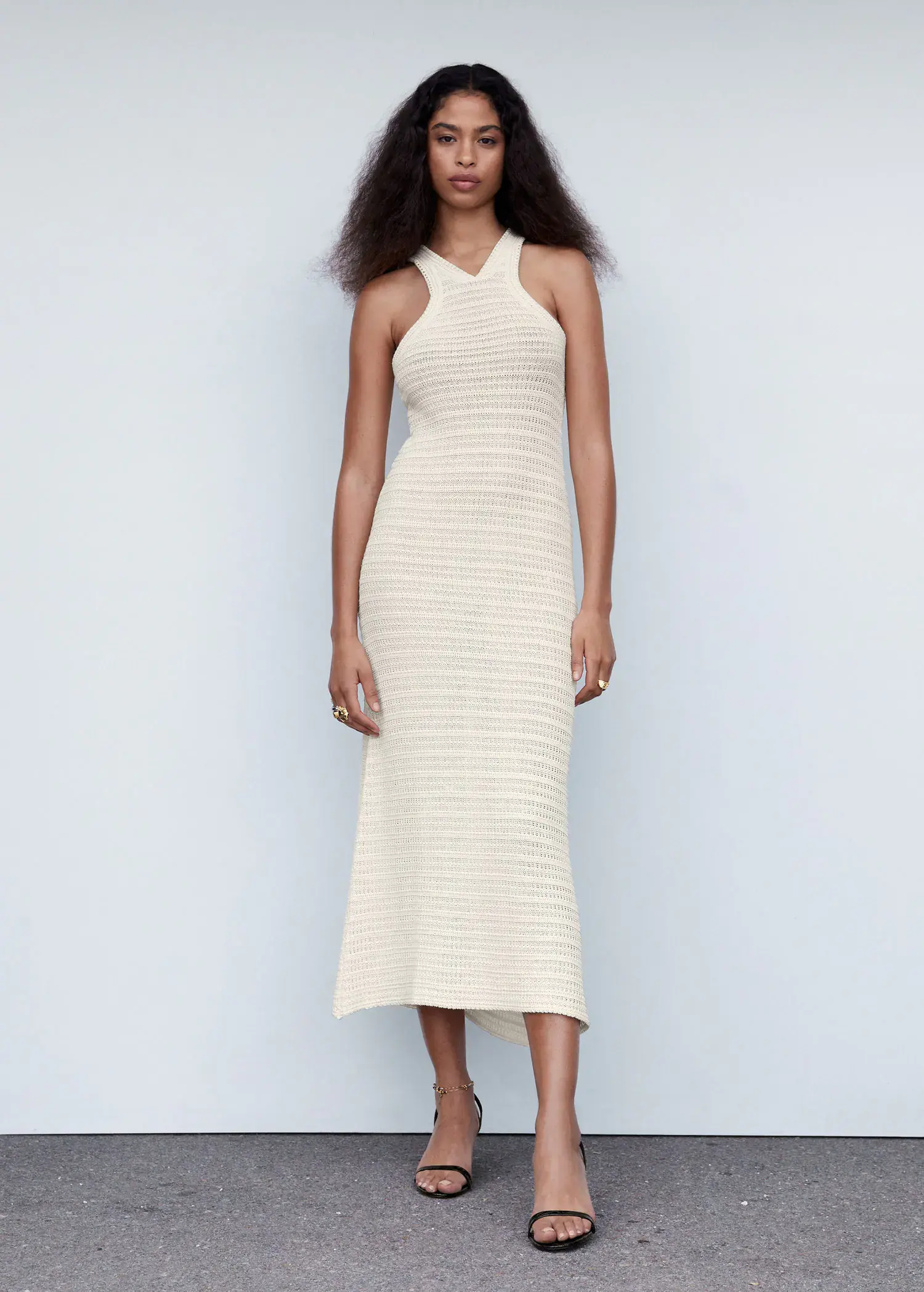 Mango Halter-neck crochet dress. a woman in a white dress standing in front of a white wall. 